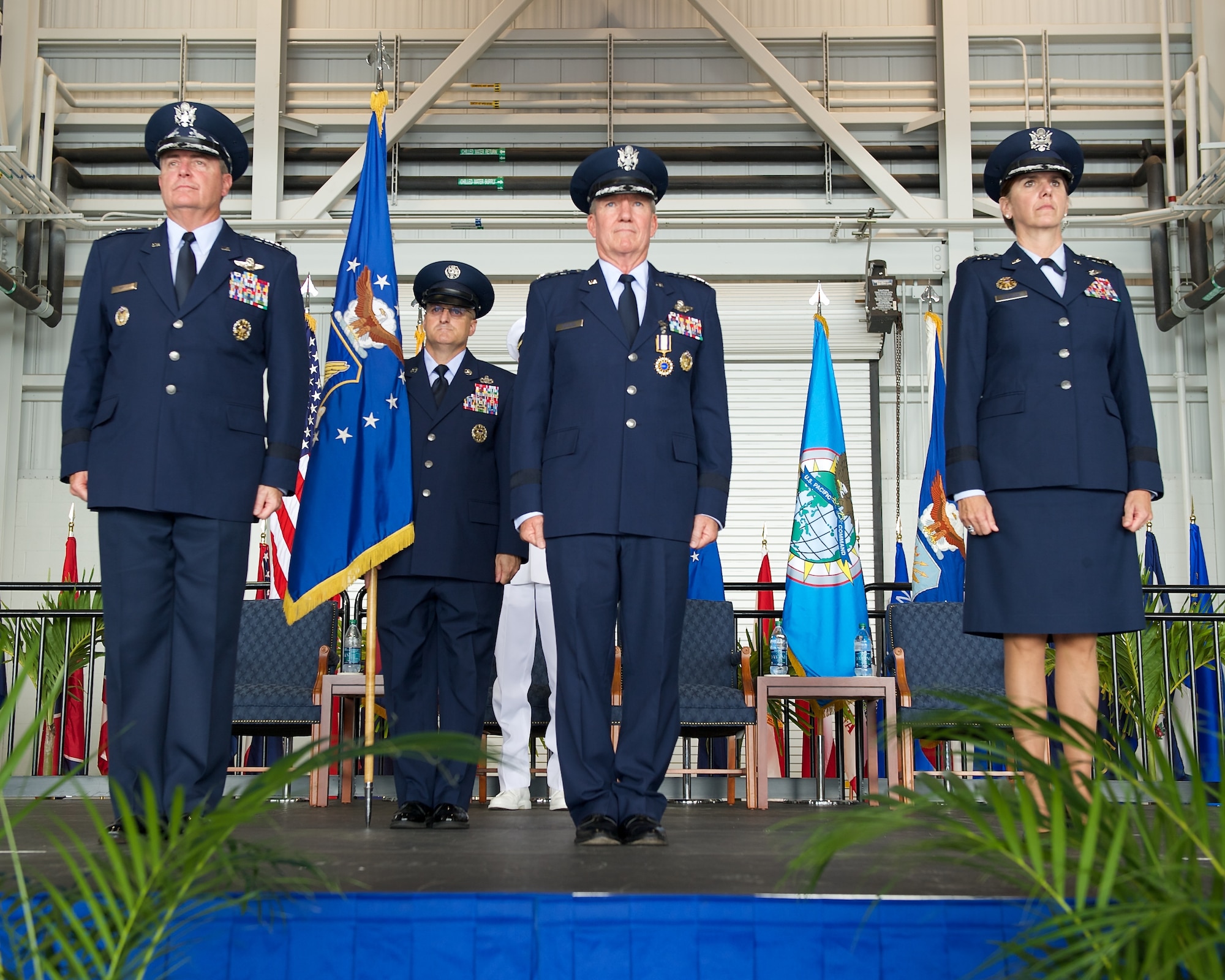 Gen. Hawk Carlisle, outgoing Pacific Air Forces commander, relinquishes the PACAF flag to Air Force Chief of Staff Gen. Mark A. Welsh III during the PACAF change of command ceremony at Joint Base Pearl Harbor-Hickam, Hawaii, Oct. 16, 2014. Gen. Lori Robinson became the first woman to lead a U.S. Air Force Component Major Command when she succeeded Carlisle during the ceremony. (U.S. Air Force photo by Tech. Sgt. James Stewart/Released)