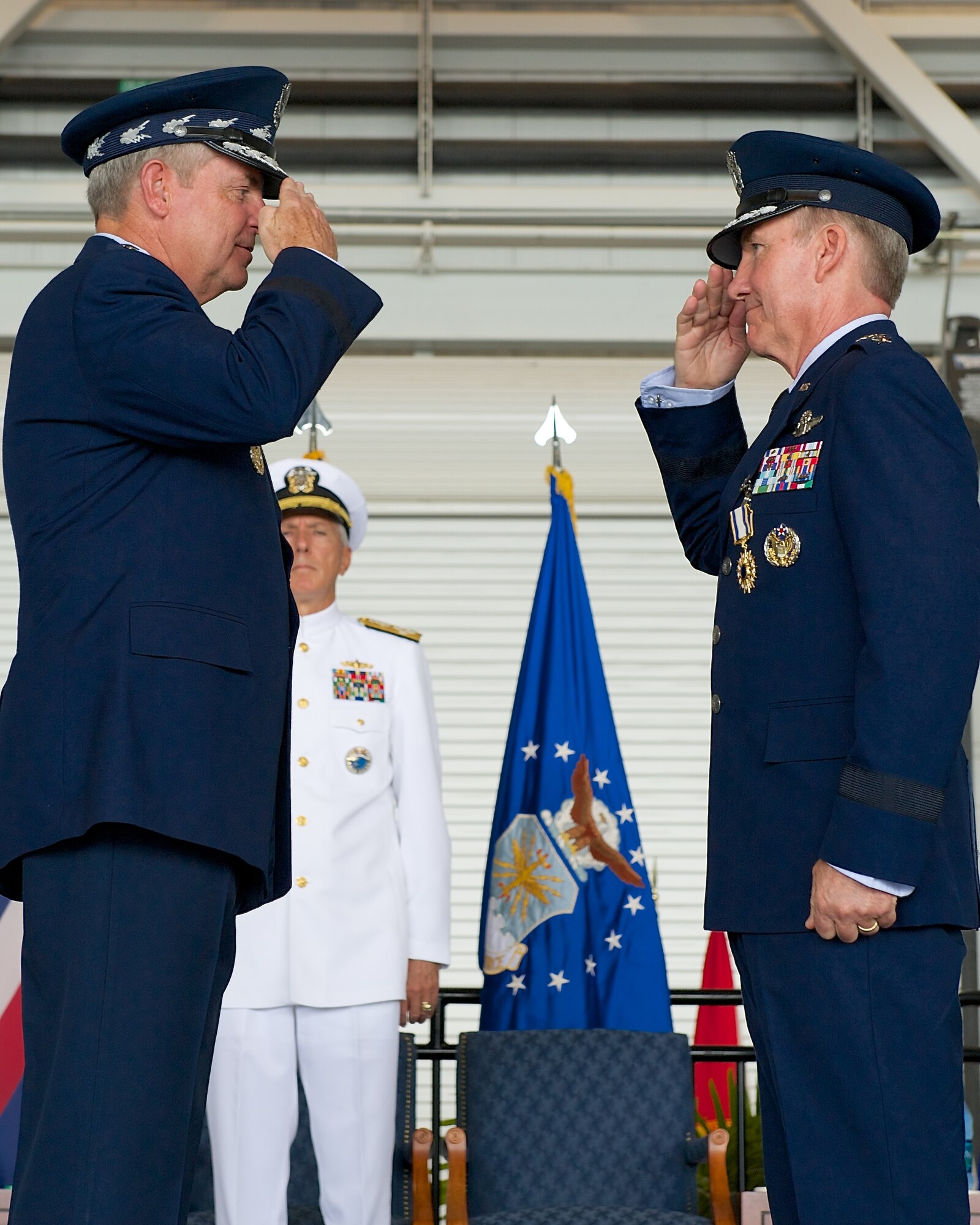 Air Force Chief of Staff Gen. Mark A. Welsh III presents Gen. Hawk Carlisle, outgoing Pacific Air Forces commander, with a Distinguished Service Medal during the PACAF change of command ceremony at Joint Base Pearl Harbor-Hickam, Hawaii, Oct. 16, 2014. Gen. Lori Robinson succeeded Carlisle during the ceremony. (U.S. Air Force photo by Tech. Sgt. James Stewart/Released)