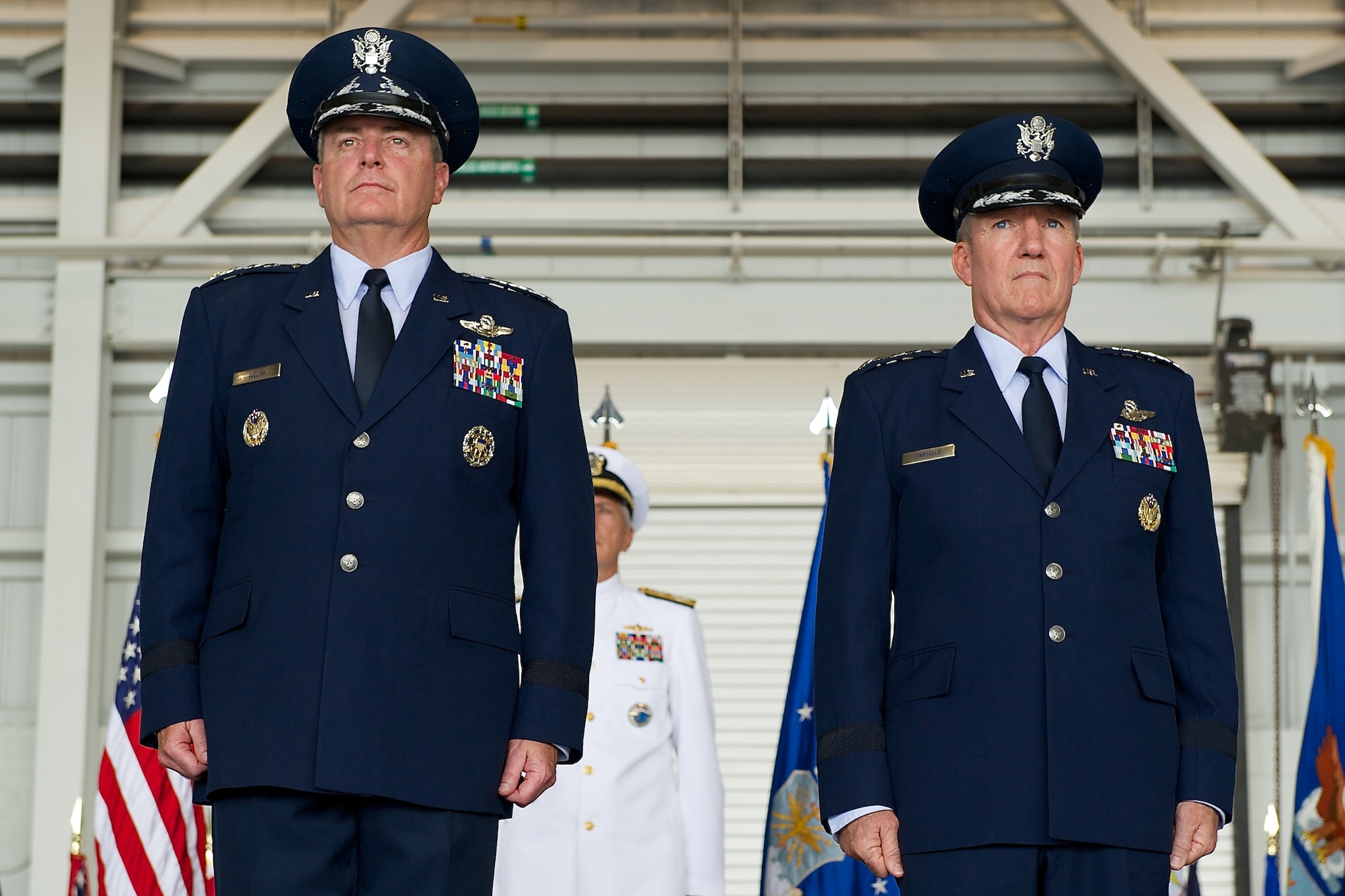 Air Force Chief of Staff Gen. Mark A. Welsh III presents Gen. Hawk Carlisle, outgoing Pacific Air Forces commander, with a Distinguished Service Medal during the PACAF change of command ceremony at Joint Base Pearl Harbor-Hickam, Hawaii, Oct. 16, 2014. Gen. Lori Robinson succeeded Carlisle during the ceremony. (U.S. Air Force photo by Tech. Sgt. James Stewart/Released)