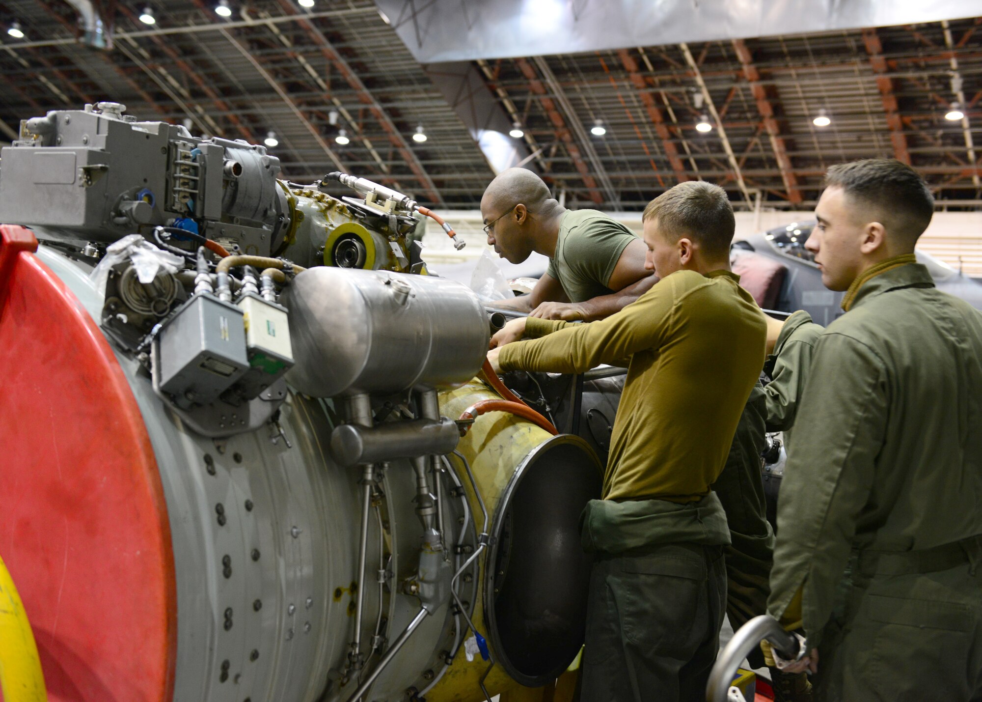 U.S. Marine Corps Marine Attack Squadron 311 maintainers, assigned to Marine Corps Air Station Yuma, Ariz., perform routine maintenance on an engine Oct. 2, 2014, during RED FLAG-Alaska 15-1 at Eielson Air Force Base, Alaska. RF-A is a series of Pacific Air Forces commander-directed field training exercises for U.S. and partner nation forces, providing combined offensive counter-air, interdiction, close air support and large force employment training in a simulated combat environment. (U.S. Air Force photo by Senior Airman Ashley Nicole Taylor/Released)