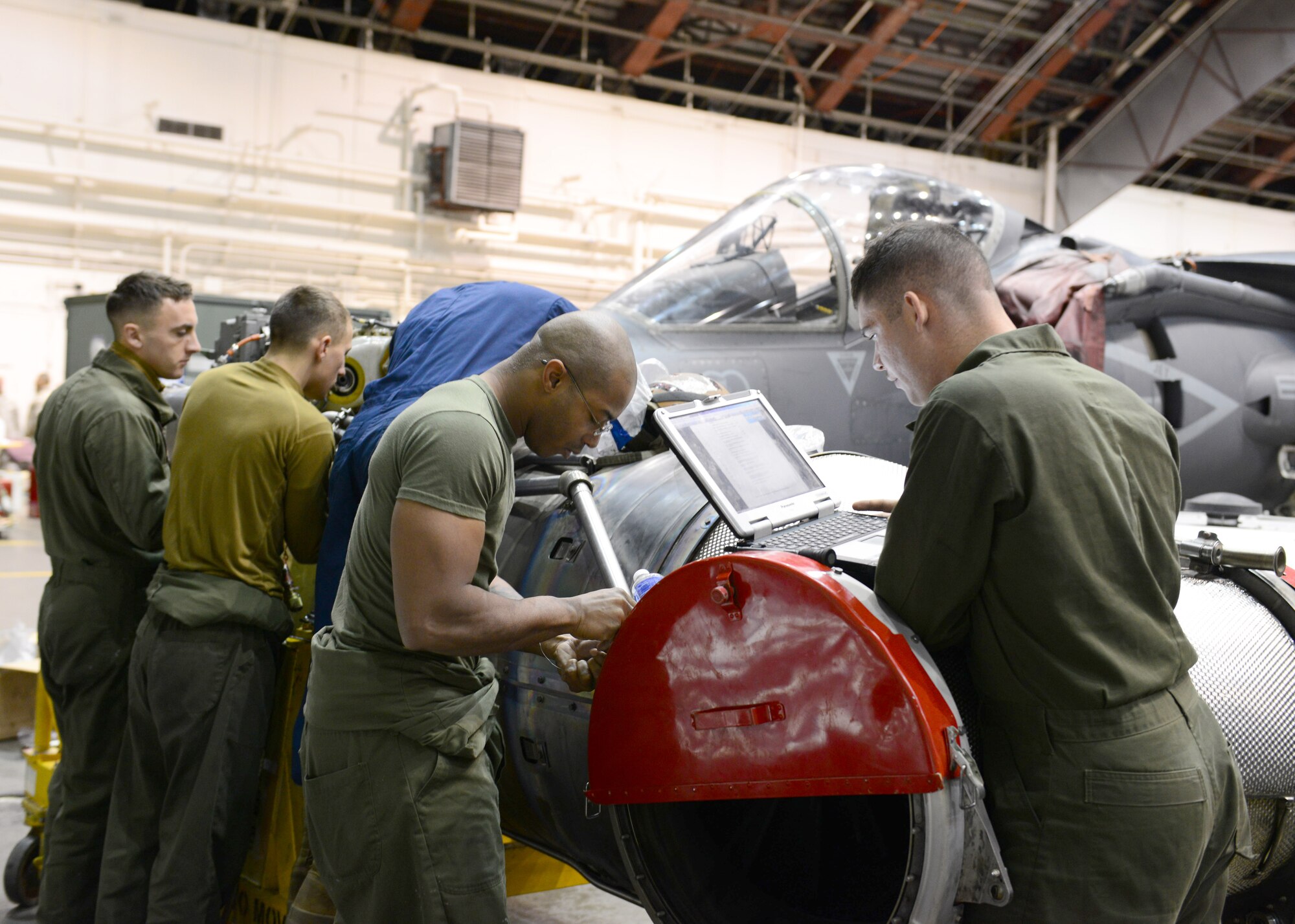 U.S. Marine Corps Marine Attack Squadron 311 maintainers, assigned to Marine Corps Air Station Yuma, Ariz., perform routine maintenance on an engine Oct. 2, 2014, during RED FLAG-Alaska 15-1 at Eielson Air Force Base, Alaska. RF-A is a series of Pacific Air Forces commander-directed field training exercises for U.S. and partner nation forces, providing combined offensive counter-air, interdiction, close air support and large force employment training in a simulated combat environment. (U.S. Air Force photo by Senior Airman Ashley Nicole Taylor/Released)