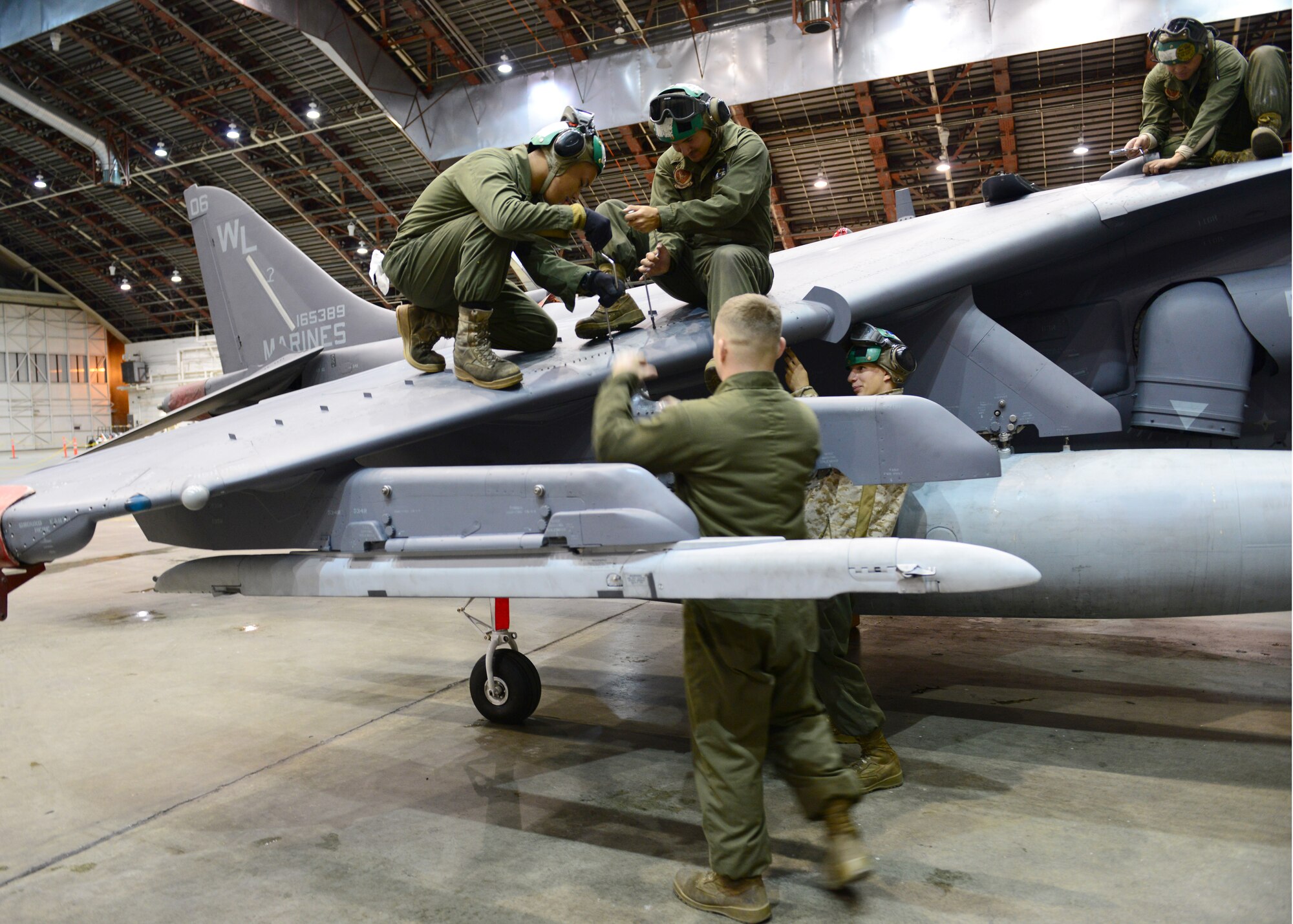 U.S. Marine Corps Marine Attack Squadron 311 maintainers, assigned to Marine Corps Air Station Yuma, Ariz., perform a post-flight inspection on an AV-8B Harrier ground attack aircraft Oct. 2, 2014, during RED FLAG-Alaska 15-1 at Eielson Air Force Base, Alaska. RF-A is a series of Pacific Air Forces commander-directed field training exercises for U.S. and partner nation forces, providing combined offensive counter-air, interdiction, close air support and large force employment training in a simulated combat environment. (U.S. Air Force photo by Senior Airman Ashley Nicole Taylor/Released)