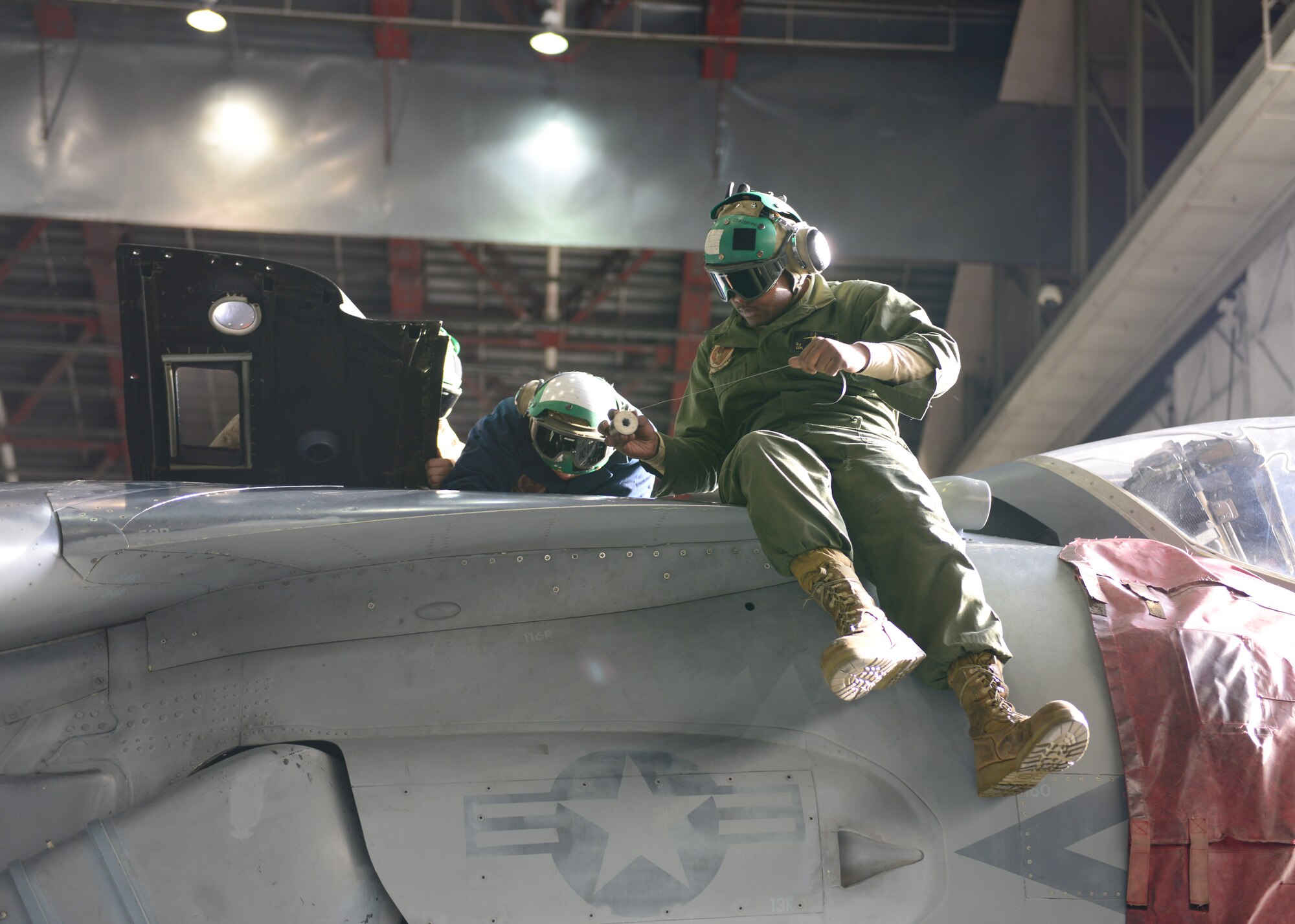 U.S. Marine Corps Marine Attack Squadron 311 maintainers, assigned to Marine Corps Air Station Yuma, Ariz., fix a digital electrical control unit on an AV-8B Harrier ground attack aircraft Sept. 26, 2014, during RED FLAG-Alaska 15-1 at Eielson Air Force Base, Alaska. RF-A is a series of Pacific Air Forces commander-directed field training exercises for U.S. and partner nation forces, providing combined offensive counter-air, interdiction, close air support and large force employment training in a simulated combat environment. (U.S. Air Force photo by Senior Airman Ashley Nicole Taylor/Released)