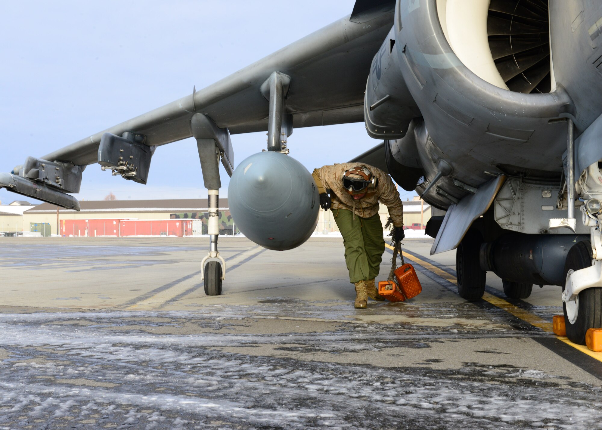 U.S. Marine Corps Cpl. Cody Davenport, a Marine Attack Squadron 311 ground support specialist, assigned to Marine Corps Air Station Yuma, Ariz., performs pre-flight inspections on an AV-8B Harrier ground attack aircraft Oct. 8, 2014, during RED FLAG-Alaska 15-1 at Eielson Air Force Base, Alaska. RF-A is a series of Pacific Air Forces commander-directed field training exercises for U.S. and partner nation forces, providing combined offensive counter-air, interdiction, close air support and large force employment training in a simulated combat environment. (U.S. Air Force photo by Senior Airman Ashley Nicole Taylor/Released)