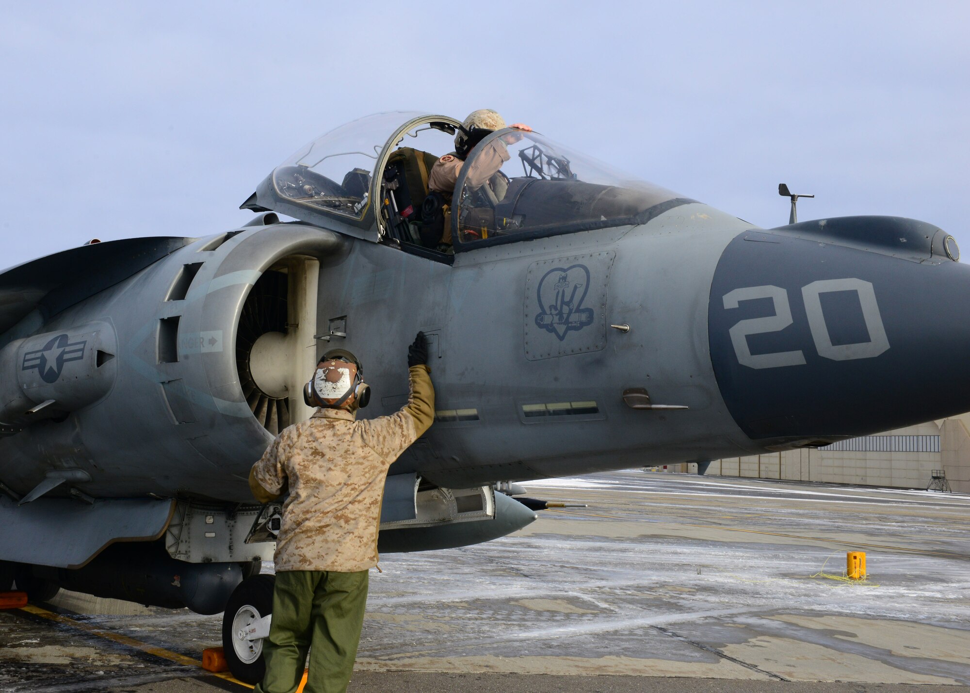 U.S. Marine Corps Cpl. Cody Davenport, Marine Attack Squadron 311 ground support specialist, prepares an AV-8B Harrier ground attack aircraft for Capt. Benjamin Boera, VMA-311 Harrier pilot, both assigned to Marine Corps Air Station Yuma, Ariz., Oct. 8, 2014, during RED FLAG-Alaska 15-1 at Eielson Air Force Base, Alaska. RF-A is a series of Pacific Air Forces commander-directed field training exercises for U.S. and partner nation forces, providing combined offensive counter-air, interdiction, close air support and large force employment training in a simulated combat environment. (U.S. Air Force photo by Senior Airman Ashley Nicole Taylor/Released)
