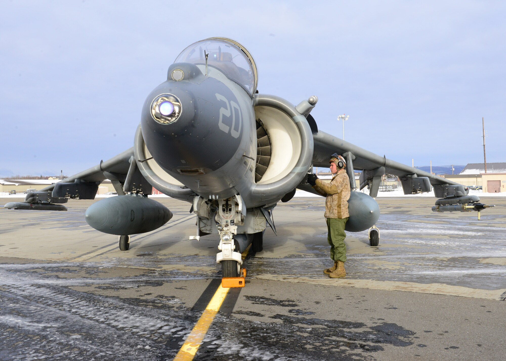 U.S. Marine Corps Cpl. Cody Davenport, a Marine Attack Squadron 311 ground support specialist, assigned to Marine Corps Air Station Yuma, Ariz., performs pre-flight inspections on an AV-8B Harrier ground attack aircraft Oct. 8, 2014, during RED FLAG-Alaska 15-1 at Eielson Air Force Base, Alaska. RF-A is a series of Pacific Air Forces commander-directed field training exercises for U.S. and partner nation forces, providing combined offensive counter-air, interdiction, close air support and large force employment training in a simulated combat environment. (U.S. Air Force photo by Senior Airman Ashley Nicole Taylor/Released)