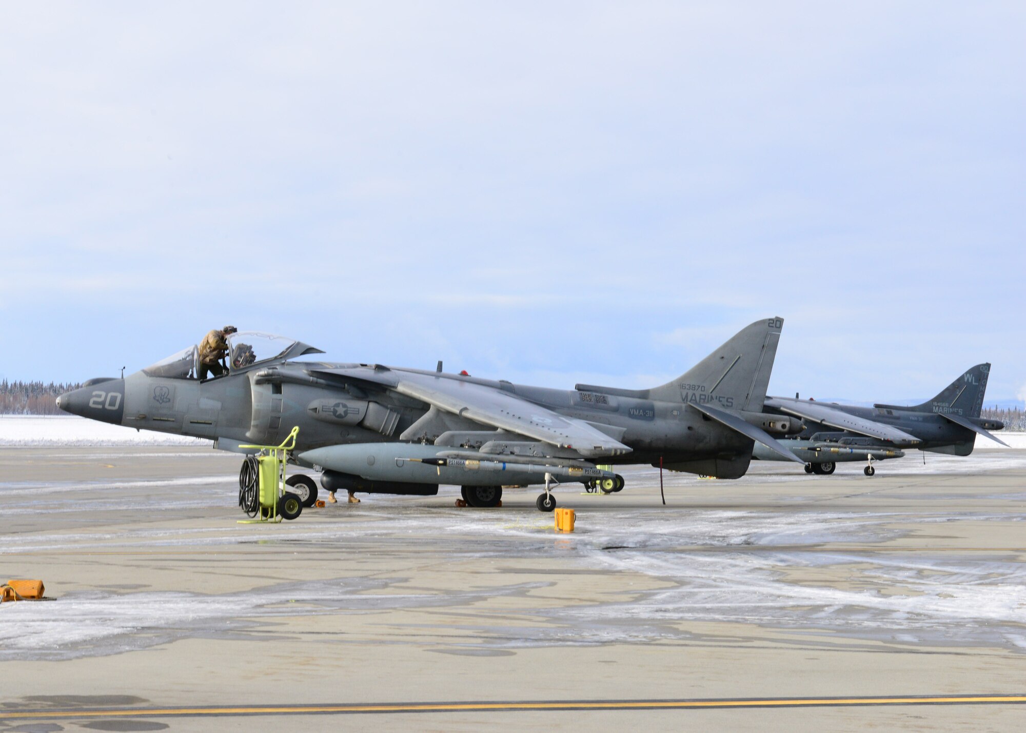 U.S. Marine Corps Cpl. Cody Davenport, a Marine Attack Squadron 311 ground support specialist, assigned to Marine Corps Air Station Yuma, Ariz., prepares an AV-8B Harrier ground attack aircraft before a sortie Oct. 8, 2014, during RED FLAG-Alaska 15-1 at Eielson Air Force Base, Alaska. RF-A is a series of Pacific Air Forces commander-directed field training exercises for U.S. and partner nation forces, providing combined offensive counter-air, interdiction, close air support and large force employment training in a simulated combat environment. (U.S. Air Force photo by Senior Airman Ashley Nicole Taylor/Released)