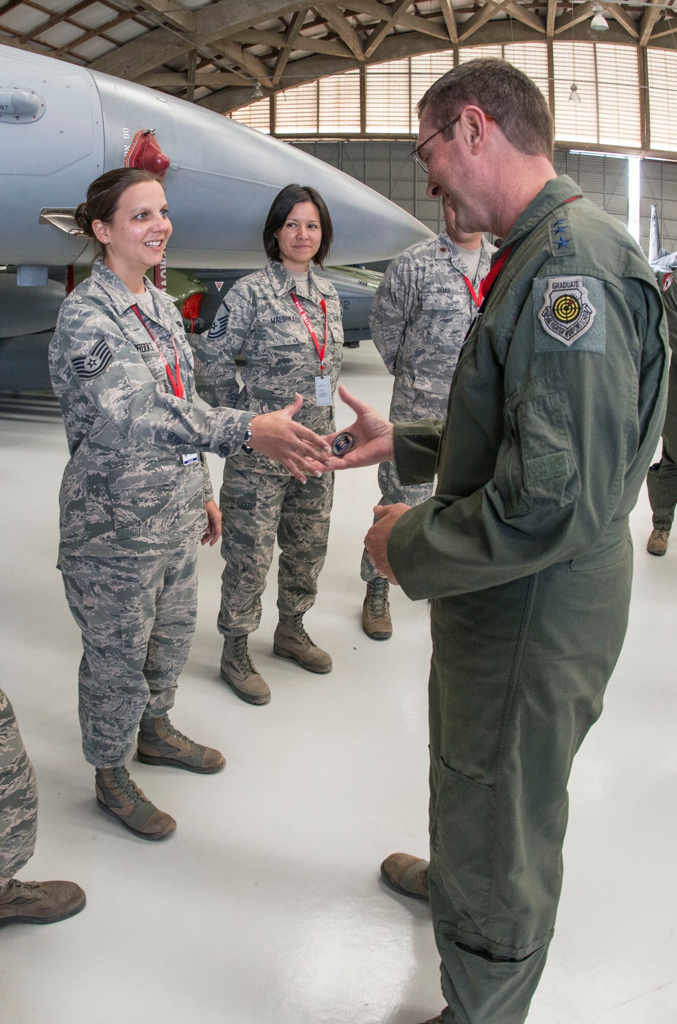 U.S. Air Force Lt. Gen. Joseph L. Lengyel, Vice Chief, National Guard Bureau coins U.S. Air Force Tech. Sgt. Lisa Brooks, 149th Fighter Wing, Texas Air National Guard, during Salitre 2014 at Cerro Moreno Air Force Base, near Antofagasta, Chile, Oct. 15. Salitre is a Chilean-led exercise where the U.S., Chile, Brazil, Argentina and Uruguay, focus on increasing interoperability between allied nations. (Air National Guard photo by Senior Master Sgt. Elizabeth Gilbert/released)