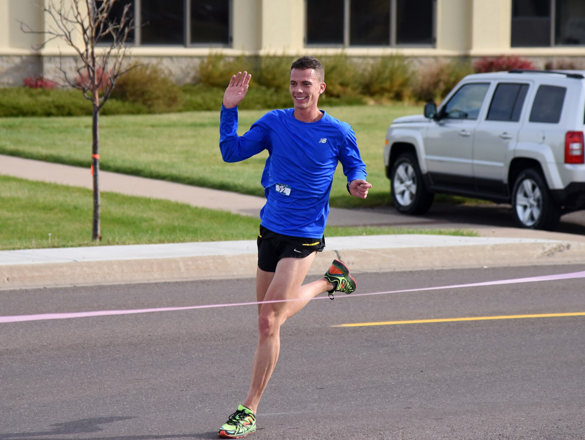 2nd Lt. James Walmsley crosses the finish line during the 2nd Annual Breast Cancer Awareness Month 5K walk/run at Malmstrom Air Force Base, Mont., Oct. 15. Malmstrom Airmen and members of the Great Falls community rallied together in support of Breast Cancer Awareness Month during a 5K walk/run. (U.S. Air Force photo/ Airman 1st Class Joshua Smoot)