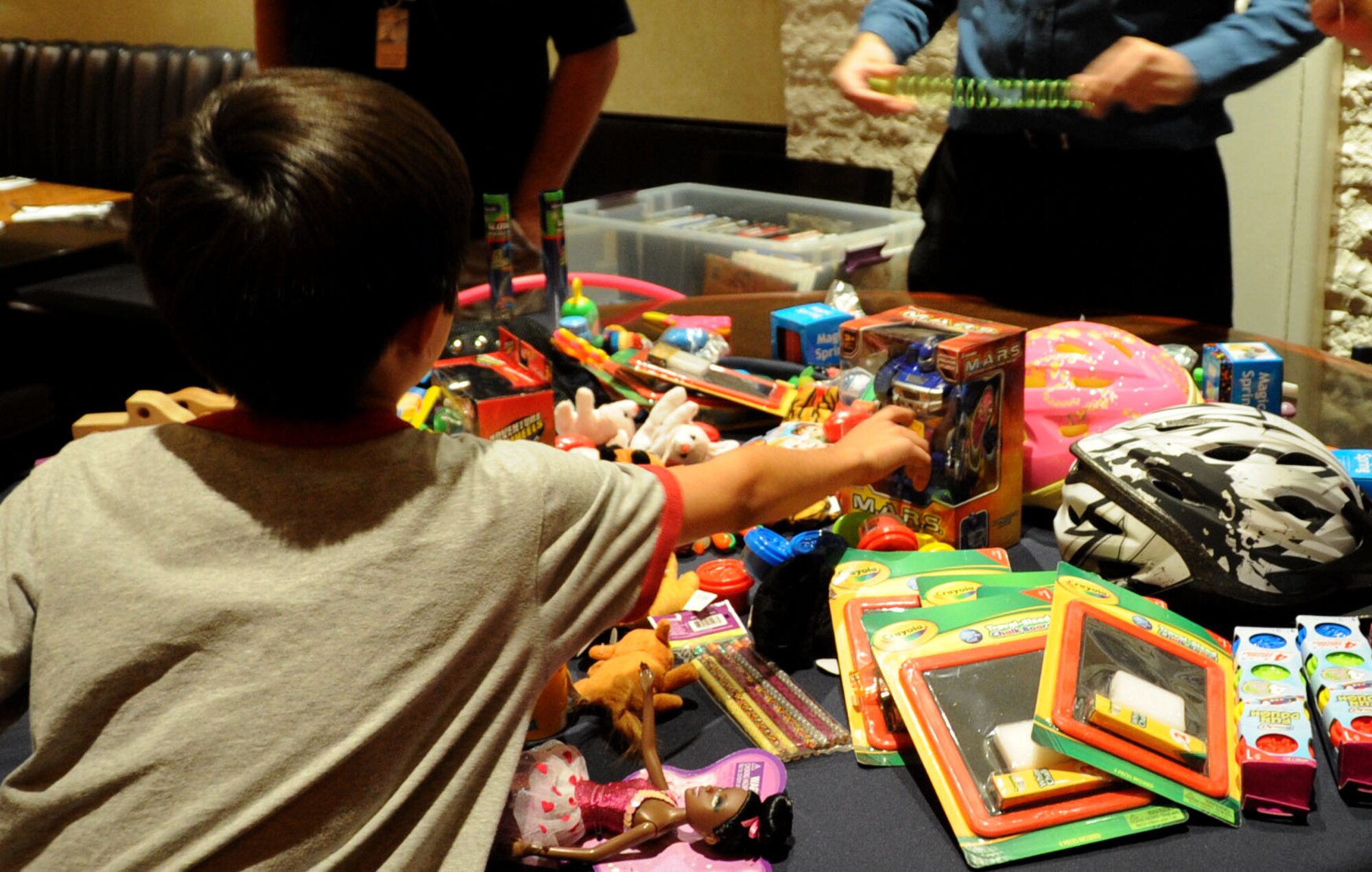 A child selects a free toy during a toy drive Oct. 15, 2014, at Aliante Hotel and Casino in Las Vegas.  The toy drive took place from Sept. 15-Oct. 15, 2014, in coordination with USO Las Vegas to benefit local military families.  (U.S. Air Force photo by Capt. Stephani Schafer/released)