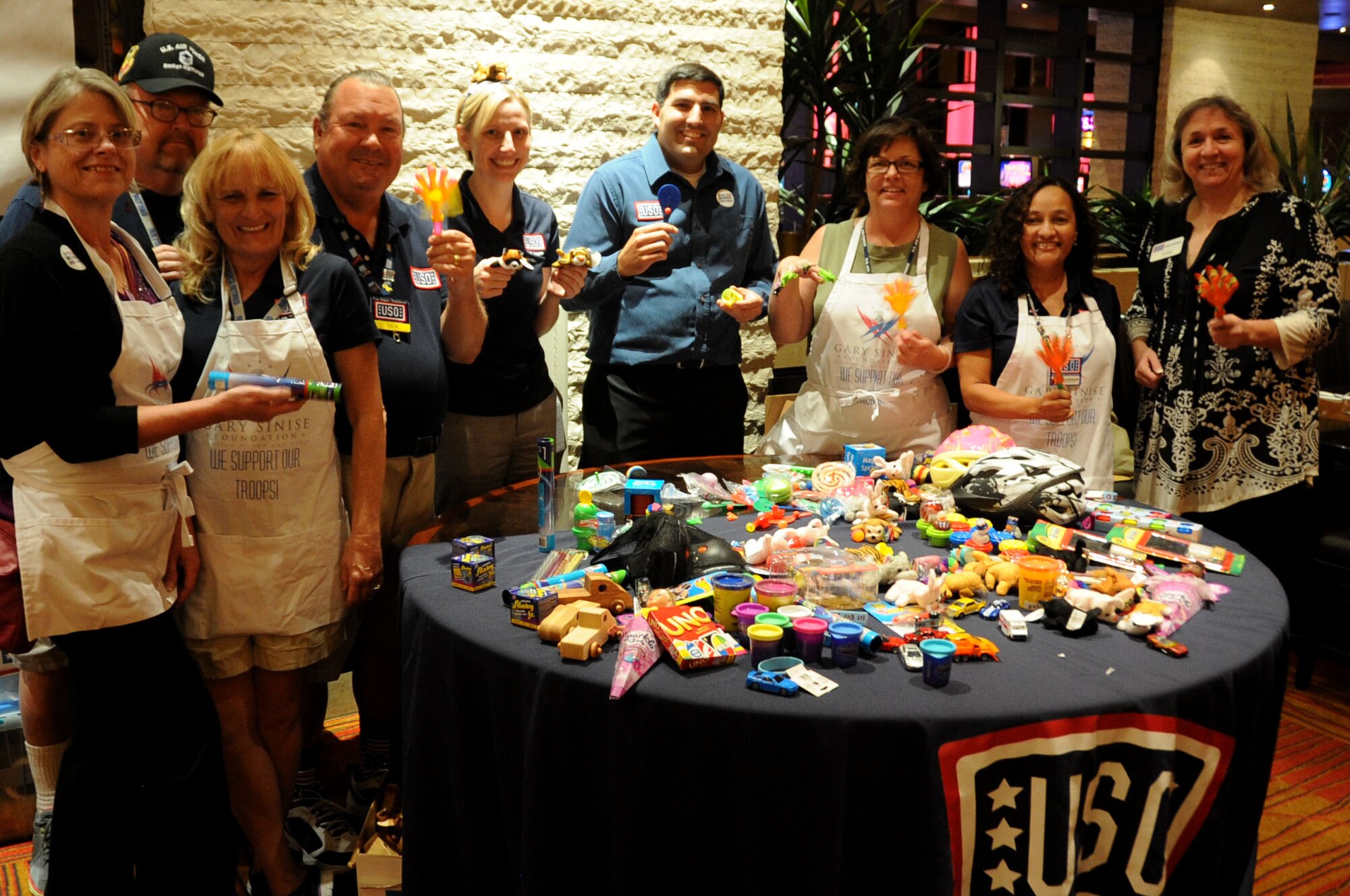 USO Las Vegas staff members and volunteers pose with toys during a toy drive benefitting military families at Aliante Hotel and Casino in Las Vegas Oct. 15, 2014.  The USO Las Vegas partnered with a local business to raise approximately $500 worth of toys during the fundraiser, which took place from Sept. 15-Oct. 15, 2014. (U.S. Air Force photo by Capt. Stephani Schafer/released)