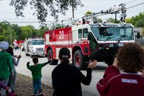 The Joint Base San Antonio-Randolph Fire Department drives their Oshkosh Striker 3000 during the 2014 Live Oak Fire Prevention Week parade Saturday in Live Oak, Texas. The event was the culmination of the week that commemorates the Great Chicago Fire of 1871 and aims to raise awareness of fire safety. (U.S. Air Force photo by Airman 1st Class Stormy Archer)