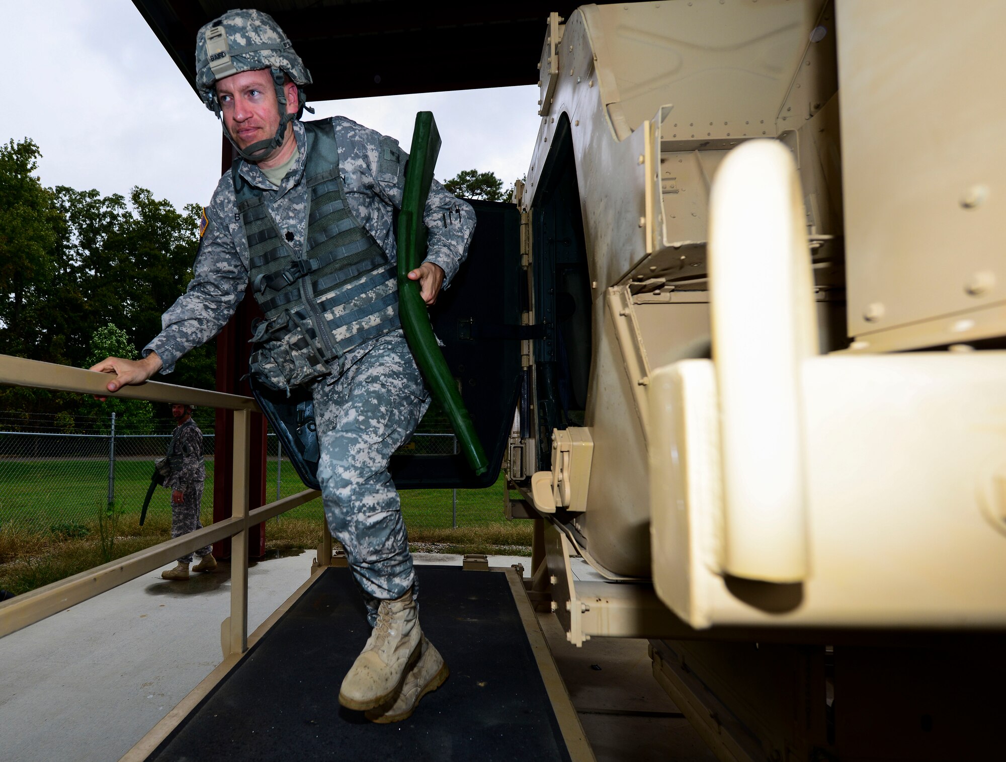 U.S. Army Lt. Col. Kevin Baird, 53rd Transportation Battalion (Movement Control) commander, egresses from a simulated Humvee rollover at Fort Eustis, Va., Oct. 15, 2014. The rollover training was conducted to ensure Soldiers can properly and safely exit an overturned vehicle during a deployment. (U.S. Air Force photo by Senior Airman Kayla Newman/Released) 