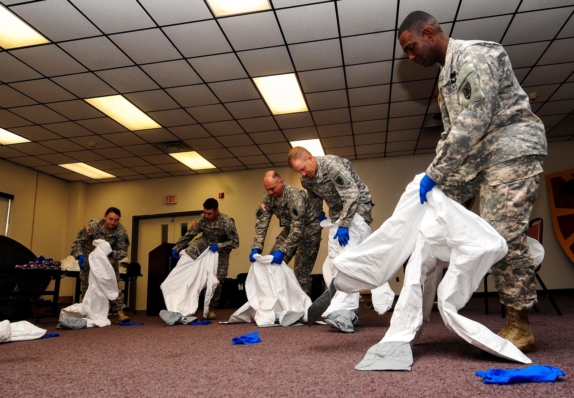 U.S. Army Soldiers from the 53rd Transportation Battalion (Movement Control), 7th Transportation Brigade (Expeditionary), learn how to don personal protective equipment at Fort Eustis, Va., Oct. 15, 2014. Although Fort Eustis personnel deploying to West Africa will not treat Ebola-infected patients, they were provided specialized training on use of PPE in the events of potential exposure. (U.S. Air Force photo by Airman 1st Class Breonna Veal) 