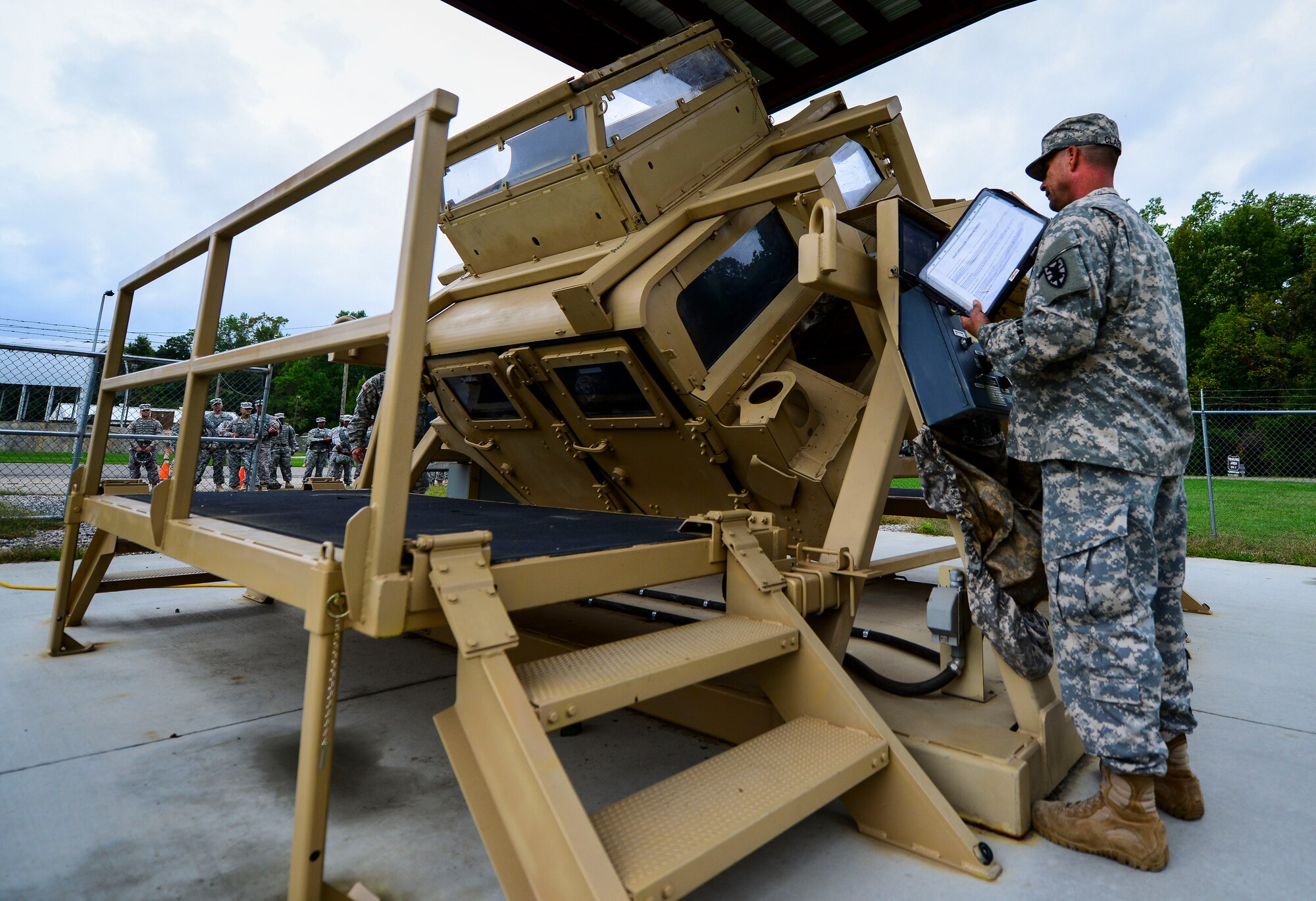 U.S. Army Staff Sgt. Edward Clarke, 53rd Transportation Battalion (Movement Control), 7th Transportation Brigade (Expeditionary) cargo specialist, monitors Soldiers as they perform Humvee rollover training at Fort Eustis, Va., Oct. 15, 2014. The 53rd Trans. Btn. (MC) specializes in the movement of Soldiers, equipment and other critical assets to deployed locations. (U.S. Air Force photo by Senior Airman Kayla Newman/Released)