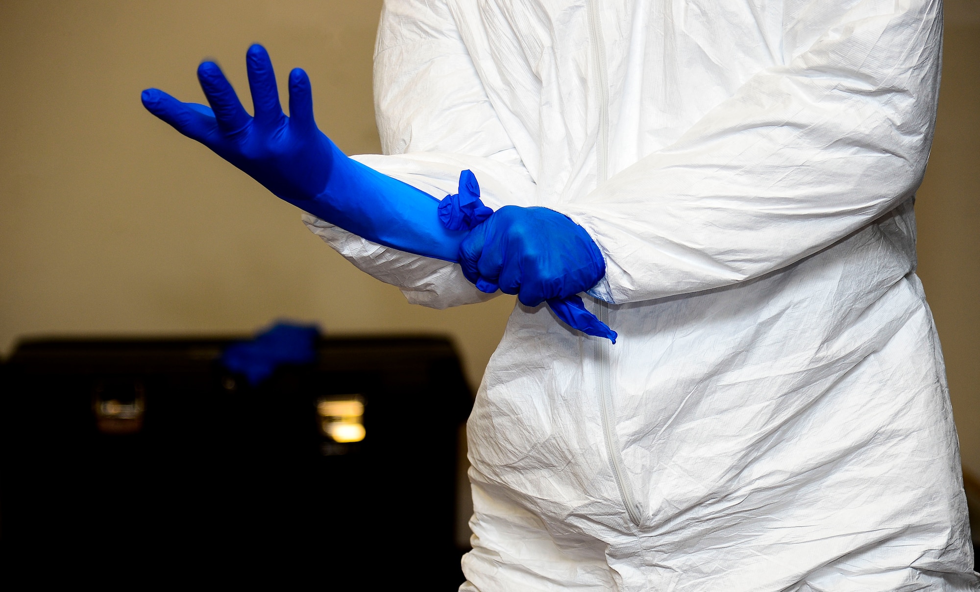 A U.S. Army Soldier practices donning personal protective equipment at Fort Eustis, Va., Oct. 15, 2014. Soldiers received training on PPE in case they need to take extra preventive care during a deployment. (U.S. Air Force photo by Senior Airman Kayla Newman/Released) 