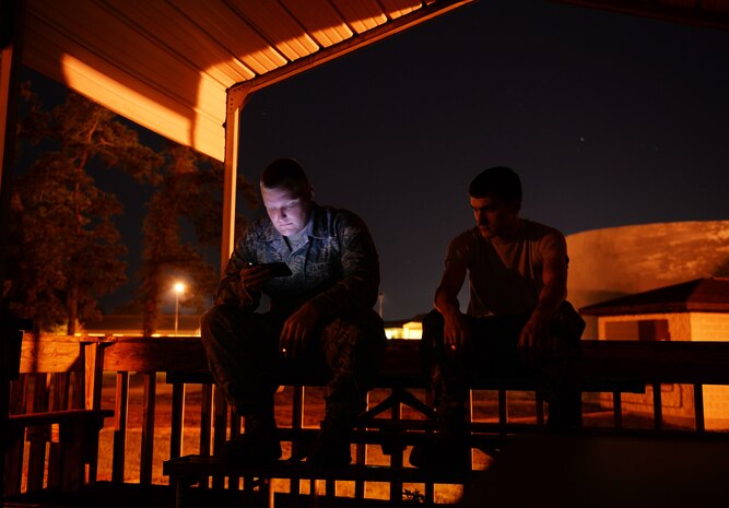 U.S. Air Force Senior Airman John Moore and Staff. Sgt. Matthew Hutchinson, 437th Aircraft Maintenance Squadron, Viper Support Flight rails specialist, take a smoke break Sept. 30, 2014, at Joint Base Charleston, S.C. The Airmen who work in the rail shop directly support the aircrafts assigned to the 437th Airlift Wing. (U.S. Air Force photo by Senior Airman Daniel Hughes)