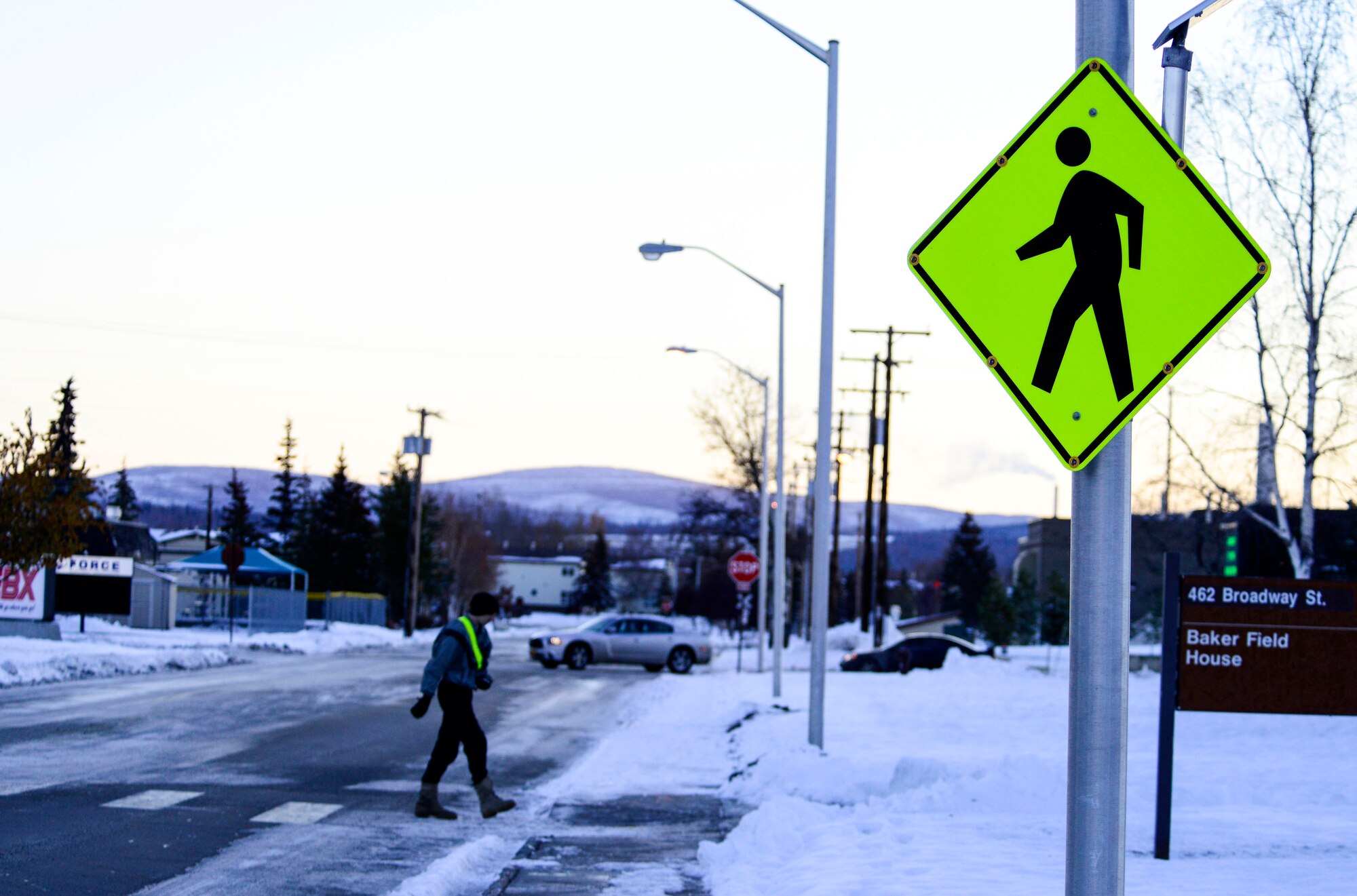 Inclement weather conditions cause visibility issues for pedestrians and drivers. Pedestrians should cross the street at marked crosswalks and if a vehicle approaches, wait for the driver to come to a complete stop before crossing. (U.S. Air Force photo by Senior Airman Racheal E. Watson/Released)