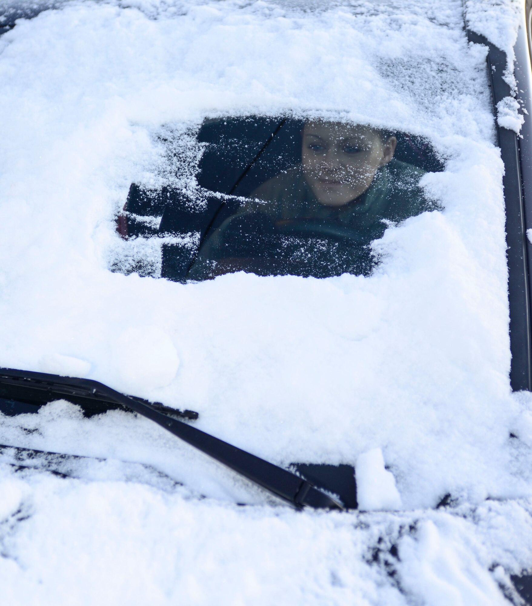 Winter weather has the potential of creating hazardous traveling conditions. According to Alaska Statute 13aac 04.225(a-b), every vehicle window must be thoroughly cleared of snow and ice before traveling or the driver takes the chance of causing an accident and being ticketed. (U.S. Air Force photo by Senior Airman Racheal E. Watson/Released)