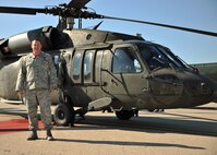 Master Sgt. Adam Hager, 319th Operations Squadron air traffic control tower chief controller, stands next to a UH-60 Blackhawk Oct. 10, 2014, on Grand Forks Air Force Base, N.D. Hager coordinated with Army Aviation Support Facility 2, 34th Combat Aviation Brigade, in Minnesota to bring their UH-60 Blackhawk to give members of the 319th OSS an opportunity to see how their jobs aid aircraft operations. (U.S. Air Force photo/Senior Airman Xavier Navarro)