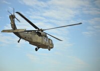 An Army National Guard UH-60 Blackhawk from the Army Aviation Support Facility 2, 34th Combat Aviation Brigade is airborne during a familiarization flight for the 319th Operations Support Squadron Oct. 10, 2014, on Grand Forks Air Force Base, N.D. The familiarization flight was a 30-minute trip which carried members of the 319th OSS from Grand Forks AFB to the city of Grand Forks. (U.S. Air Force photo/Senior Airman Xavier Navarro)