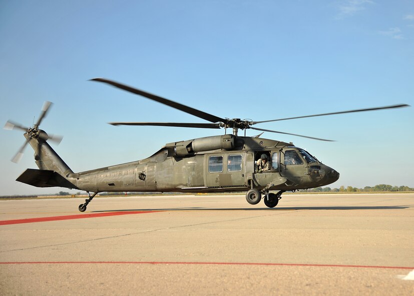 A Minnesota Army National Guard UH-60 Blackhawk from Army Aviation Support Facility 2, 34th Combat Aviation Brigade, begins to ascend during a familiarization flight for the 319th Operations Support Squadron on Oct. 10, 2014, on Grand Forks Air Force Base, N.D. The familiarization flight was a 30-minute trip which carried members of the 319th OSS from Grand Forks AFB to the city of Grand Forks. (U.S. Air Force photo/Senior Airman Xavier Navarro)