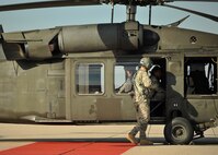 A Minnesota Army National Guard 34th Combat Aviation Brigade member prepares 319th Operations Support Squadron members for a familiarization flight in a UH-60 Blackhawk Oct. 10, 2014 on Grand Forks Air Force Base, N.D. The familiarization flight was for members who work on or around the airfield to broaden their understanding of the scope of the mission. (U.S. Air Force photo/Senior Airman Xavier Navarro)