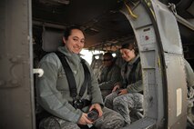 Senior Airman Sara Guajardo, 319th Operations Support Squadron airfield management shift leader, Senior Airman Rae Steichen, 319th OSS weather forecaster and Airman 1st Class Iteria Walker, 319th OSS airfield management apprentice, wait to take off on a familiarization flight from Grand Forks Air Force Base, N.D., Oct. 10, 2014. Members of the 319th OSS got a chance to ride along in a UH-60 Blackhawk in order to help foster rapport between the two units. (U.S. Air Force photo/Senior Airman Xavier Navarro) 