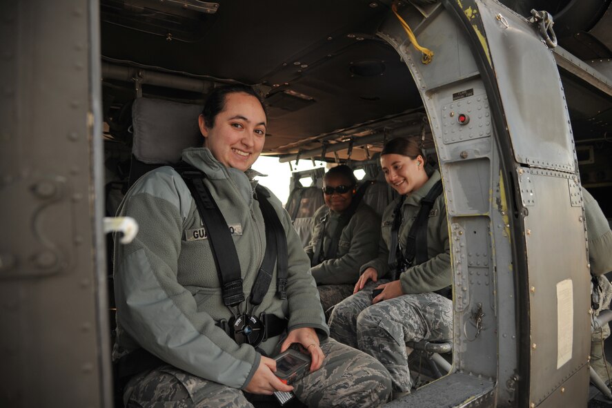 Senior Airman Sara Guajardo, 319th Operations Support Squadron airfield management shift leader, Senior Airman Rae Steichen, 319th OSS weather forecaster and Airman 1st Class Iteria Walker, 319th OSS airfield management apprentice, wait to take off on a familiarization flight from Grand Forks Air Force Base, N.D., Oct. 10, 2014. Members of the 319th OSS got a chance to ride along in a UH-60 Blackhawk in order to help foster rapport between the two units. (U.S. Air Force photo/Senior Airman Xavier Navarro) 
