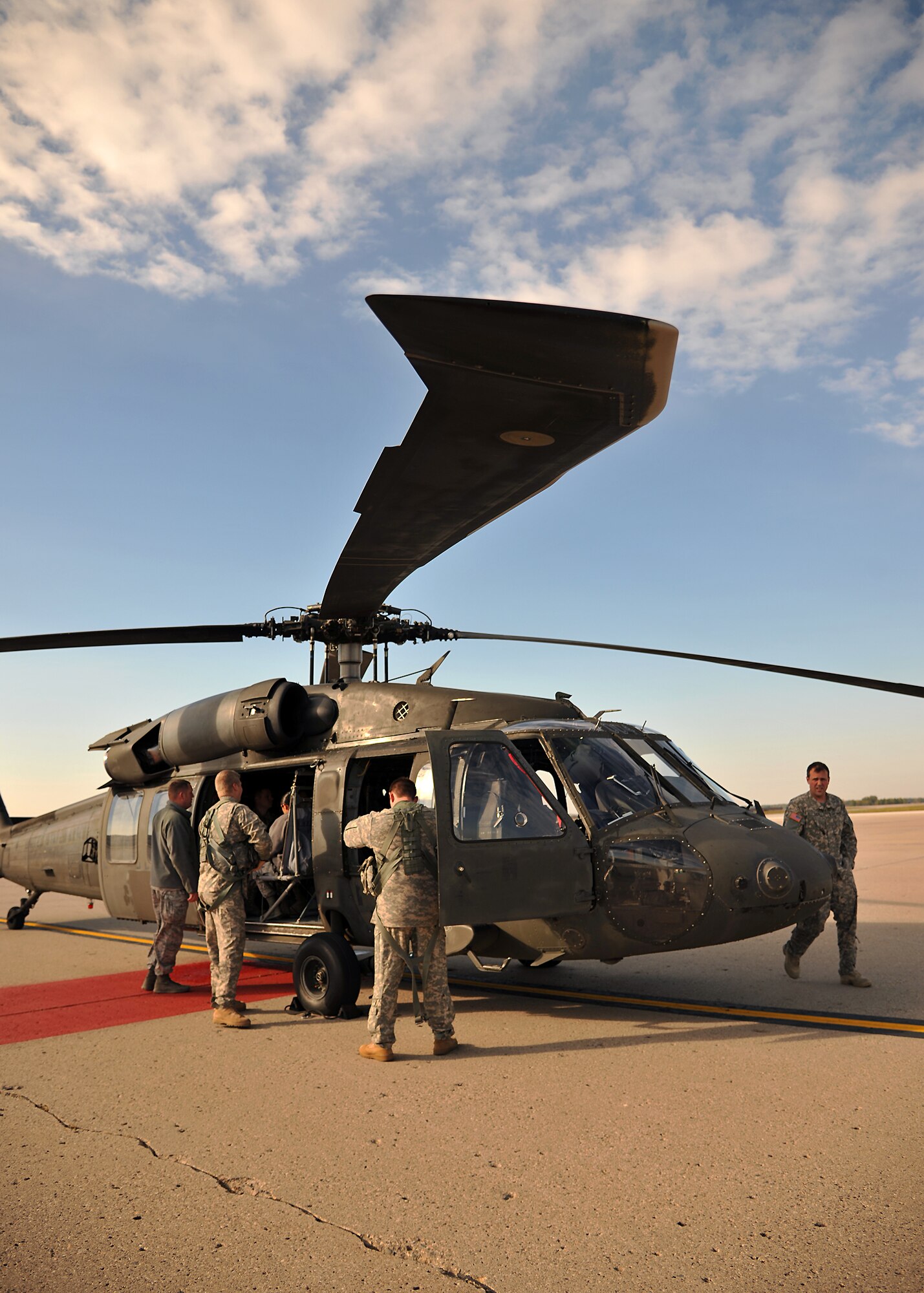 Members of the Minnesota Army National Guard 34th Combat Aviation Brigade prepare an UH-60 Blackhawk for a familiarization flight for 319th Operations Support Squadron members on Oct. 10, 2014, on Grand Forks Air Force Base, N.D. The Army Aviation Support Facility 2 flew their UH-60 Blackhawk to Grand Forks AFB to give air traffic controllers, airfield managers and other 319th OSS members a bird’s eye view of their part of the mission. (U.S. Air Force photo/Senior Airman Xavier Navarro)