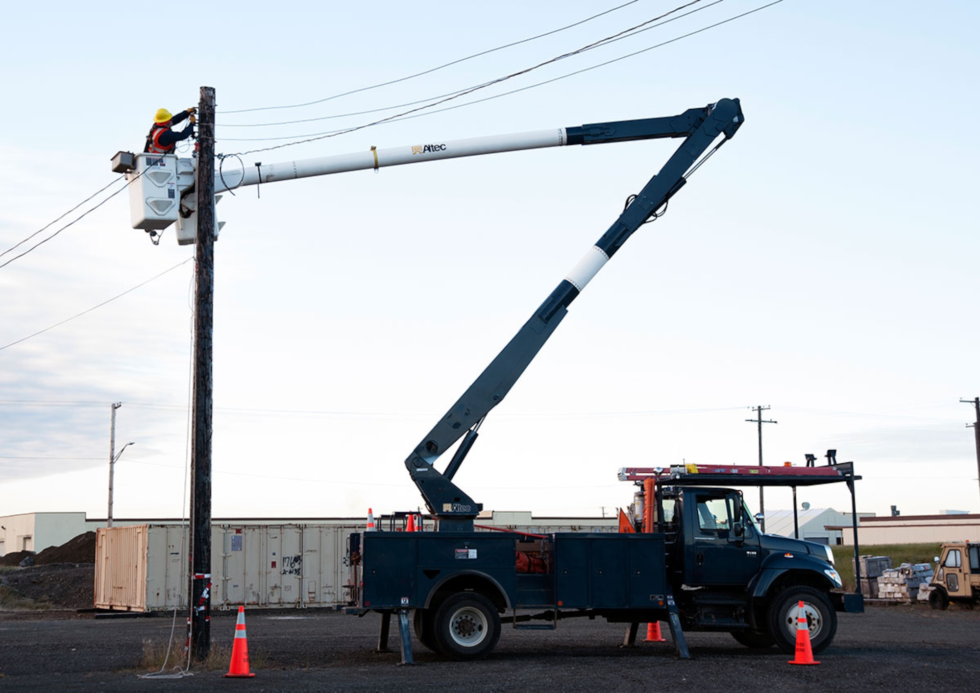 An electrician cuts old powerline cable on Joint Base Elmendorf-Richardson, Alaska, Oct. 15, 2014. The cables are no longer needed to be used and will be recycled or reused if the cables are salvageable. (U.S. Air Force photo/Airman 1st Class Tammie Ramsouer)