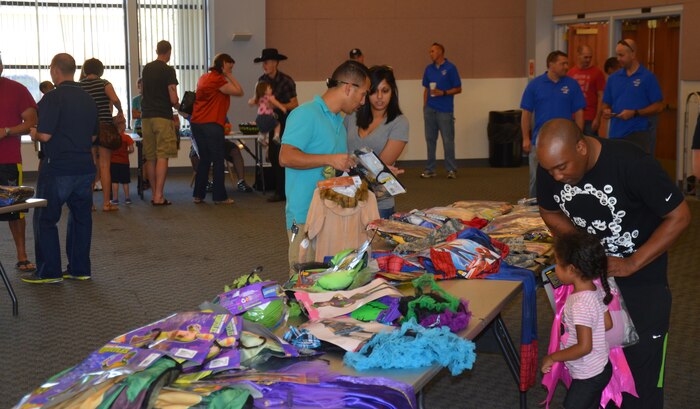 Members of Team Beale search for Halloween costumes at the Community Activity Center on Beale Air Force Base, Calif., Oct. 11, 2014. Beale’s First Sergeant Council donated nearly 150 costumes to Team Beale. (U.S. Air Force photo by Airman 1st Class Logan Lasko/Released)  