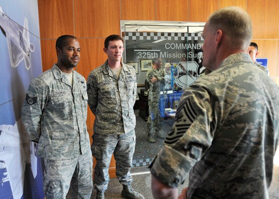 Chief Master Sgt. of the Air Force James A. Cody speaks with Staff Sgt. David Thomas, 325th Civil Engineer Squadron explosive ordnance disposal craftsman (left), and Staff Sgt. James Hendel, 325th CES EOD craftsman (middle), about being in the last EOD flight in Afghanistan, Oct. 8, at the 325th Mission Support Group. Hendel and Thomas came home after being deployed with the 466th EOD Operating Location Bravo Flight Sept. 11. (U.S. Air Force photo by Airman 1st Class Sergio A. Gamboa)