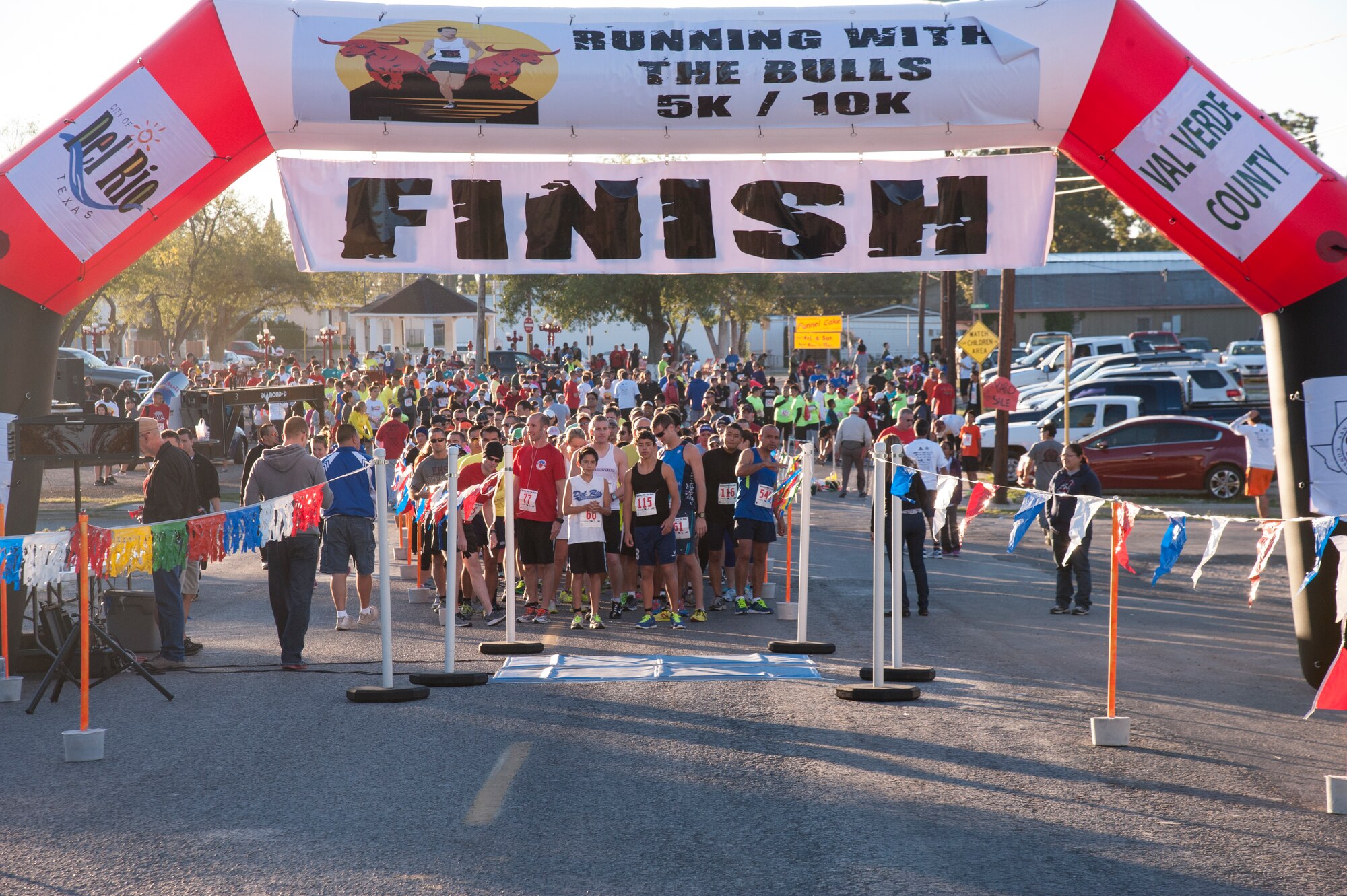 Runners prepare at the starting line for the 2013 Running with the Bulls 5K and 10K at the Brown Plaza in Del Rio, Texas, Nov. 2, 2013. Last year, the event raised more than $50,000 and more than 3,000 pounds of food for the local non-profit food bank. (U.S. Air Force photo by Senior Airman Nathan Maysonet)(Released)