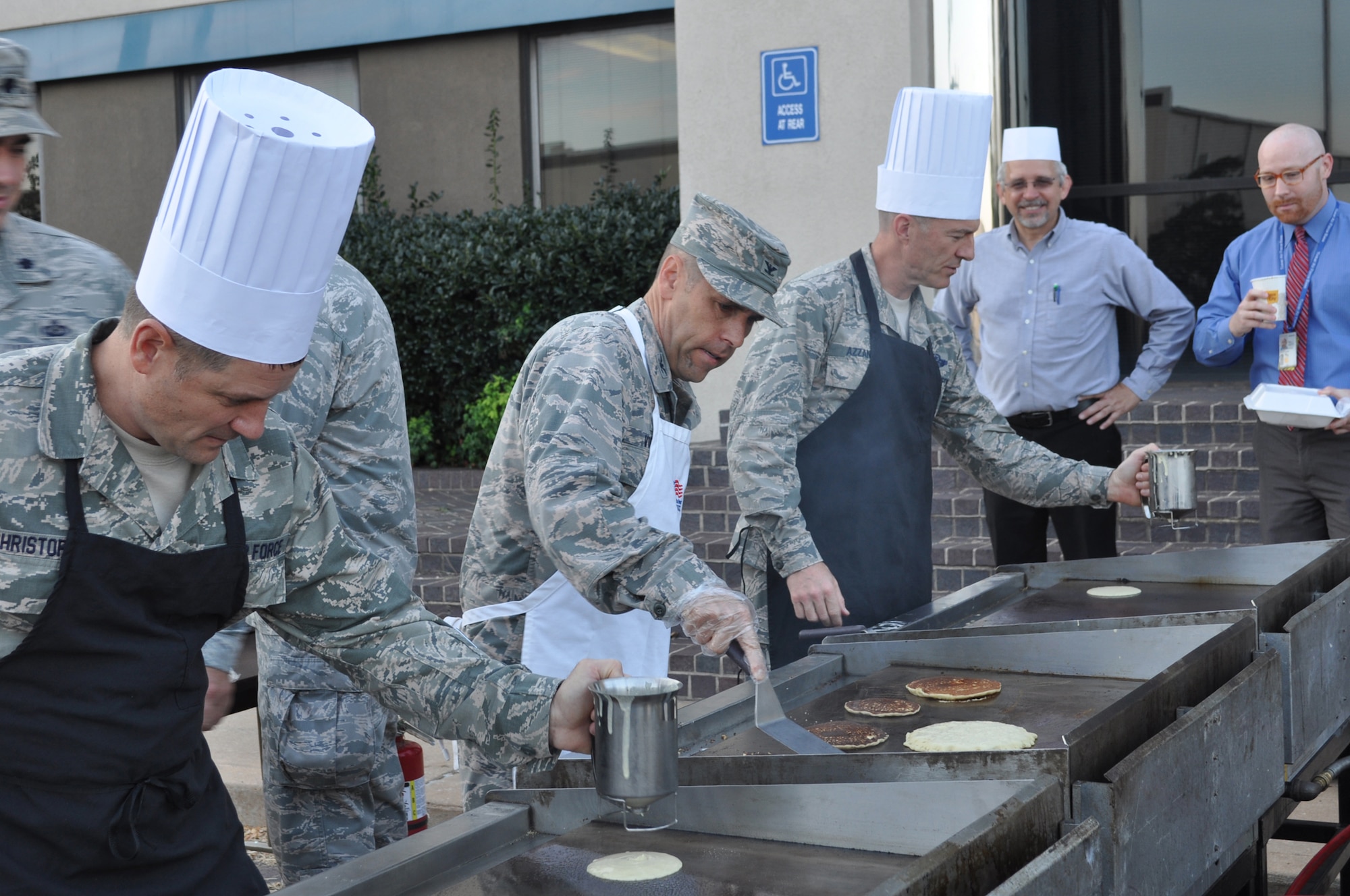 Serving up hotcakes 72nd Air Base Wing-style are, from left, 72nd ABW Command Chief Master Sgt. Thomas Christopher, 72nd Mission Support Group Commander Col. Todd Vician and 72nd ABW Commander Col. Christopher Azzano. The wing’s breakfast to support the Combined Federal Campaign was held Oct. 1 outside Bldg. 460. (Air Force photo by Michael S. Della Vecchio)