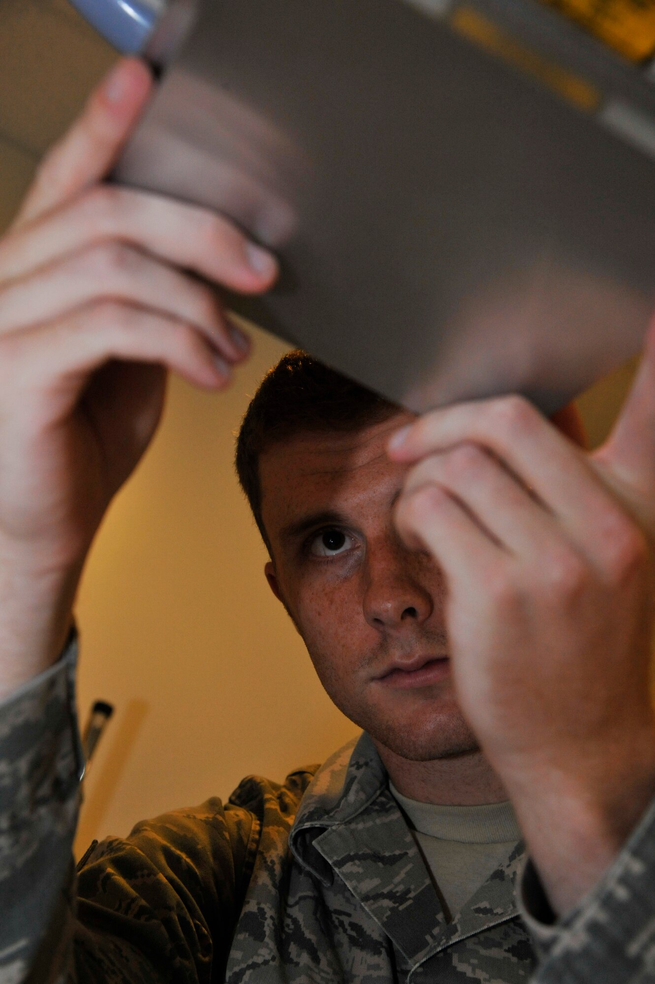 U.S. Air Force Senior Airman Matthew Syrier, 509th Medical Support Squadron radiologist, inserts a led shielding for quality assurance program at Whiteman Air Force Base, Mo., Sept. 23, 2014. This routine test is done to ensure the room is operating at optimal levels.  
(U.S. Air Force photo by Airman 1st Class Keenan Berry/Released)
