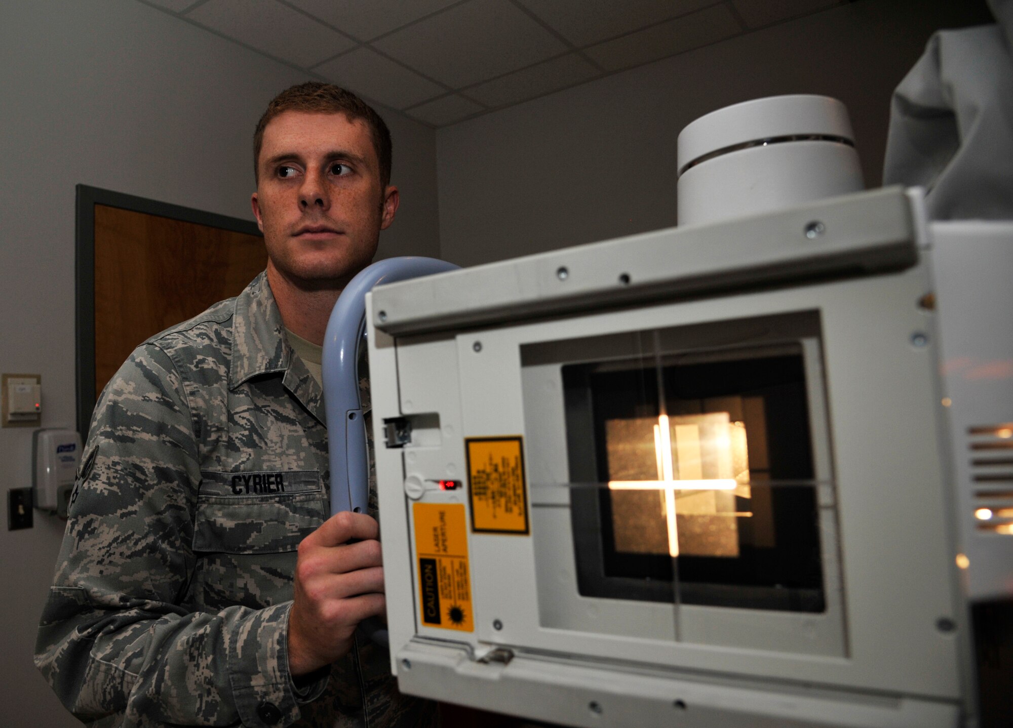 U.S. Air Force Senior Airman Matthew Syrier, 509th Medical Support Squadron radiologist, checks for image receptor alignment at Whiteman Air Force Base, Mo., Sept. 23, 2014. This procedure is done before performing a scoliosis survey.
(U.S. Air Force photo by Airman 1st Class Keenan Berry/Released)
