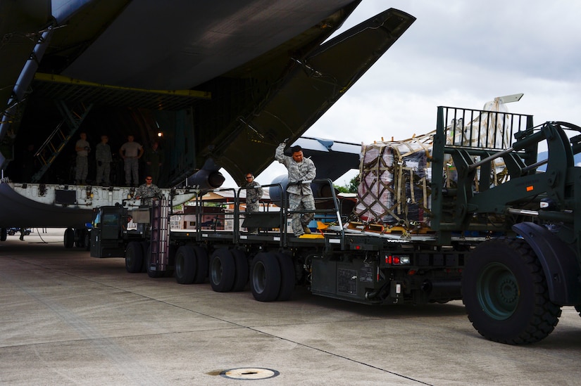 Crew members of a C-5 Galaxy from Westover Air Reserve Base, Mass., and members from the 612th Air Base Squadron unload a shipment of donated goods at Soto Cano Air Base, Honduras, Oct. 11, 2014.  The cargo transporting aircraft delivered over 6,000-pounds of humanitarian aid and supplies that were donated to Honduran citizens in need through the Denton Program.  The Denton Program allows private U.S. citizens and organizations to use space available on U.S. military cargo planes to transport humanitarian goods to approved countries in need. (U.S. Air Force photo/Tech. Sgt. Heather Redman)