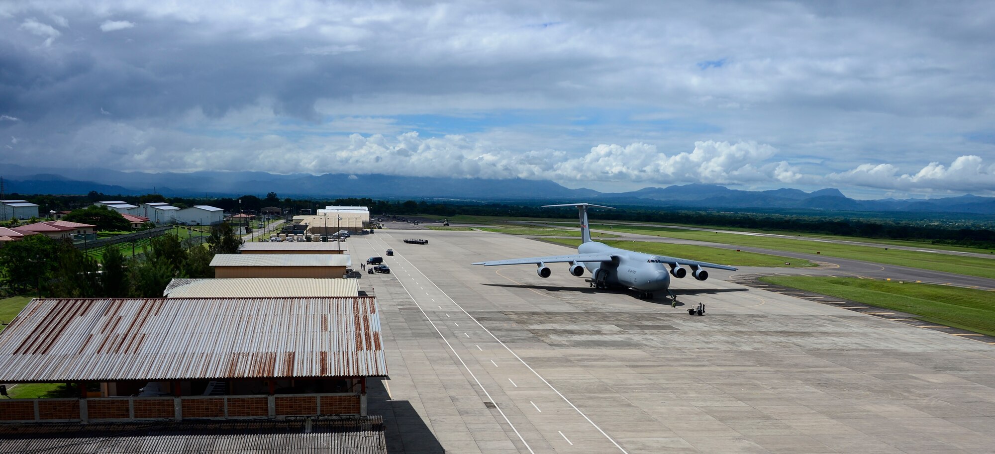 Crew members of a C-5 Galaxy from Westover Air Reserve Base, Mass., prepare to unload their cargo of donated goods at Soto Cano Air Base, Honduras, Oct. 11, 2014.  The cargo transporting aircraft delivered over 6,000-pounds of humanitarian aid and supplies that were donated to Honduran citizens in need through the Denton Program.  The Denton Program allows private U.S. citizens and organizations to use space available on U.S. military cargo planes to transport humanitarian goods to approved countries in need. (U.S. Air Force photo/ Tech. Sgt. Heather Redman)