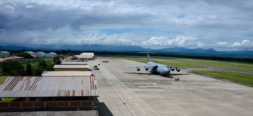 Crew members of a C-5 Galaxy from Westover Air Reserve Base, Mass., prepare to unload their cargo of donated goods at Soto Cano Air Base, Honduras, Oct. 11, 2014.  The cargo transporting aircraft delivered over 6,000-pounds of humanitarian aid and supplies that were donated to Honduran citizens in need through the Denton Program.  The Denton Program allows private U.S. citizens and organizations to use space available on U.S. military cargo planes to transport humanitarian goods to approved countries in need. (U.S. Air Force photo/ Tech. Sgt. Heather Redman)