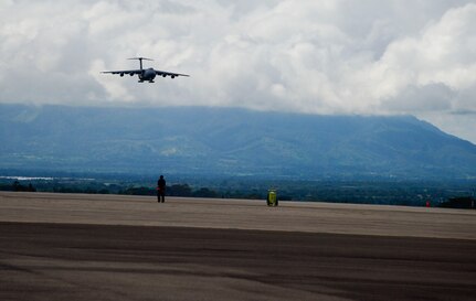 A C-5 Galaxy from Westover Air Reserve Base, Mass., approaches Soto Cano Air Base, Honduras, Oct. 11, 2014.  The cargo transporting aircraft delivered over 6,000-pounds of humanitarian aid and supplies that were donated to Honduran citizens in need through the Denton Program.  The Denton Program allows private U.S. citizens and organizations to use space available on U.S. military cargo planes to transport humanitarian goods to approved countries in need. (U.S. Air Force photo/Tech. Sgt. Heather Redman)