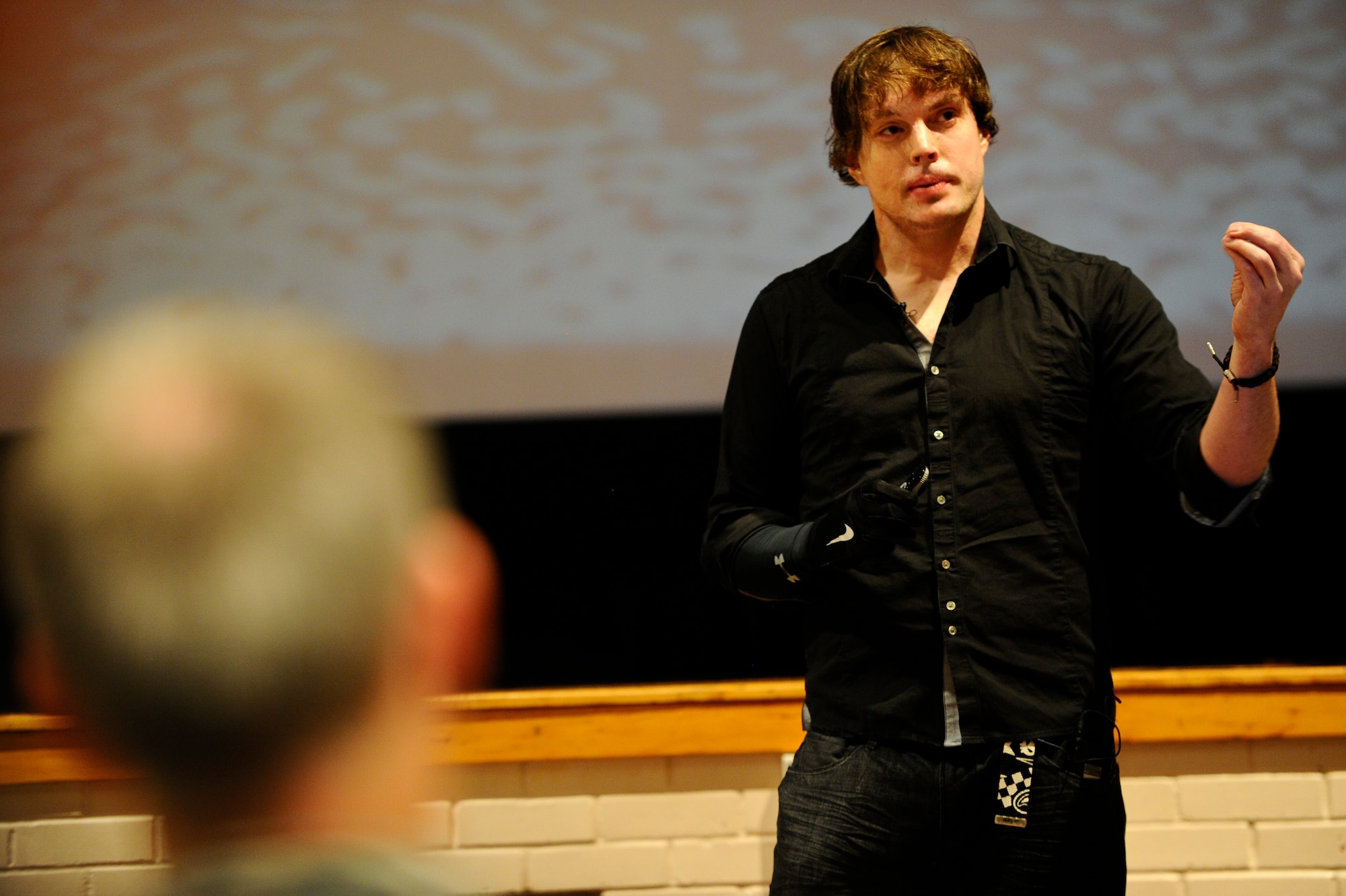 Jared Estes, survivor of an alcohol related car crash, speaks to members of McConnell Air Force Base, Kan., during a wingman day event, Oct. 10, 2014. Estes spent nearly a decade recovering from the wounds of a car crash and the death of his wife. He shared his story of recovery to the members of Team McConnell. (U.S. Air Force photo/Airman 1st Class John Linzmeier) 
