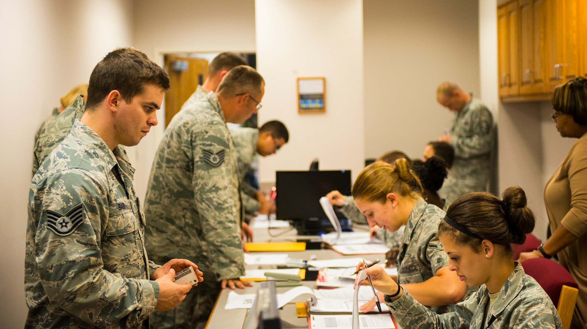 Members of the 822d Base Defense Squadron move through a deployment line Oct. 8, 2014, at Moody Air Force Base, Ga. Moody paused a Wing Readiness Inspection to process a real world deployment departure. (U.S. Air Force photo by Airman 1st Class Ceaira Tinsley/Released)