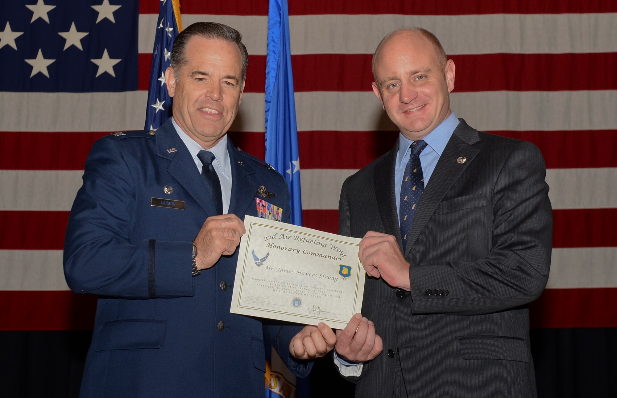 Col. Mark S. Larson, 931st Air Refueling Group commander, presents James Havers-Strong, ABI Group of Companies CEO and managing director, his certificate designating him as an Honorary Commander, during an Honorary Change of Command ceremony here, Oct. 15, 2014. The Honorary Commander Program is a joint venture between the active duty 22nd Air Refueling Wing and the Reserve 931st ARG. The program pairs local community leaders with unit commanders in order to foster strong relationships between McConnell Air Force Base and civilian leaders. (U.S. Air Force photo by Airman 1st Class Colby Hardin)