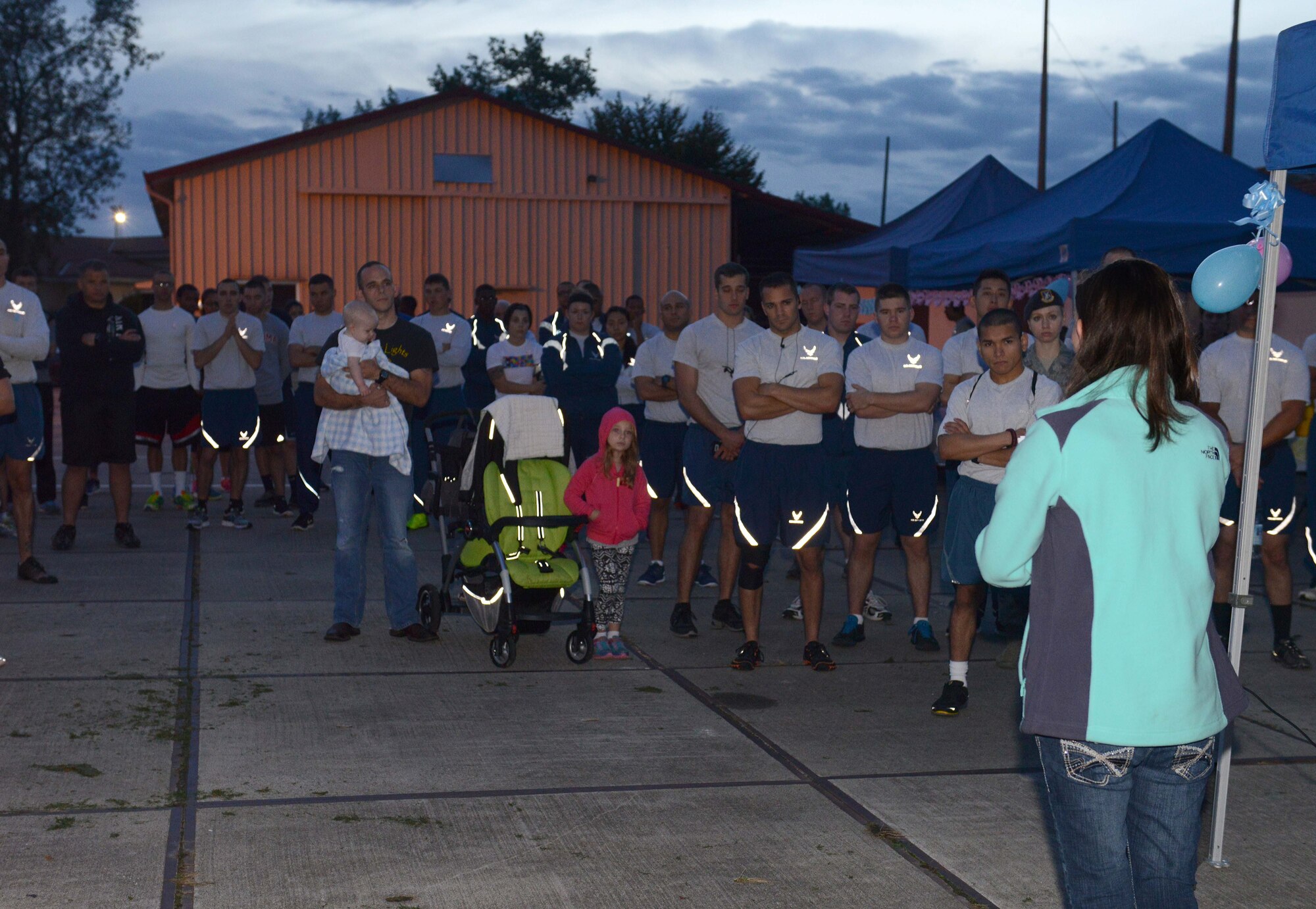 Participants listen to a story shared by Tabitha Ryan during a Sudden Infant Death Syndrome awareness 5K, Oct. 15, 2014, at Aviano Air Base, Italy. SIDS is an unexplained death that takes the life of more than 2,500 newborns. Placing infants on their back to sleep could reduce the risk of SIDS. Ryan is the wife of Senior Airman Jordan Ryan, 31st Maintenance Squadron. (U.S. Air Force photo/Airman 1st Class Deana Heitzman)