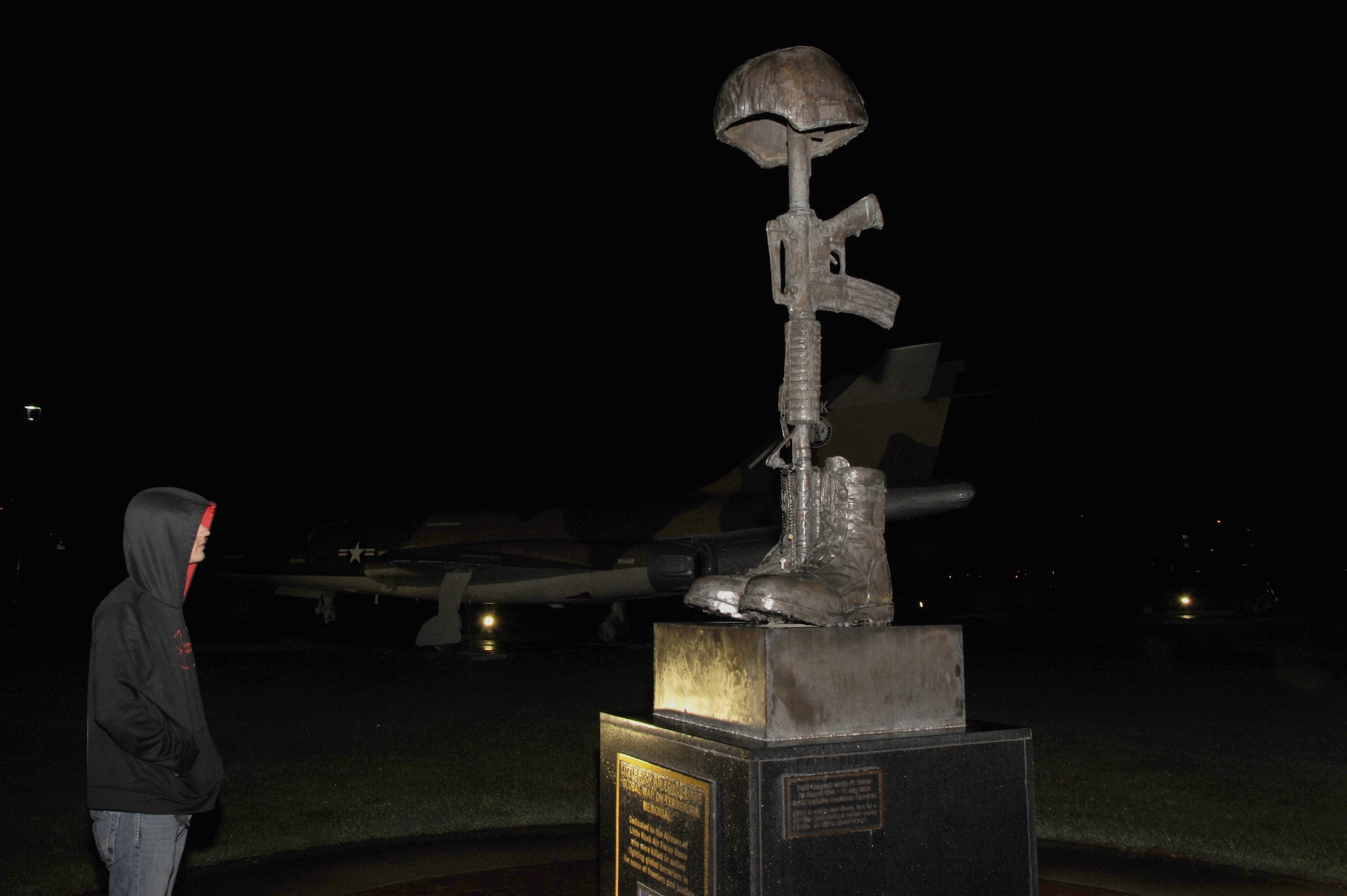 Airman 1st Class Zachary Mooneyhan, a 19th Communications Squadron network infrastructure technician, looks at the Global War on Terrorism Memorial Oct. 13, 2014, at Little Rock Air Force Base, Ark. When Taps is announced, Little Rock AFB falls still and silent to remember those who have fallen while serving. (U.S. Air Force photo by Airman 1st Class Mercedes Muro)