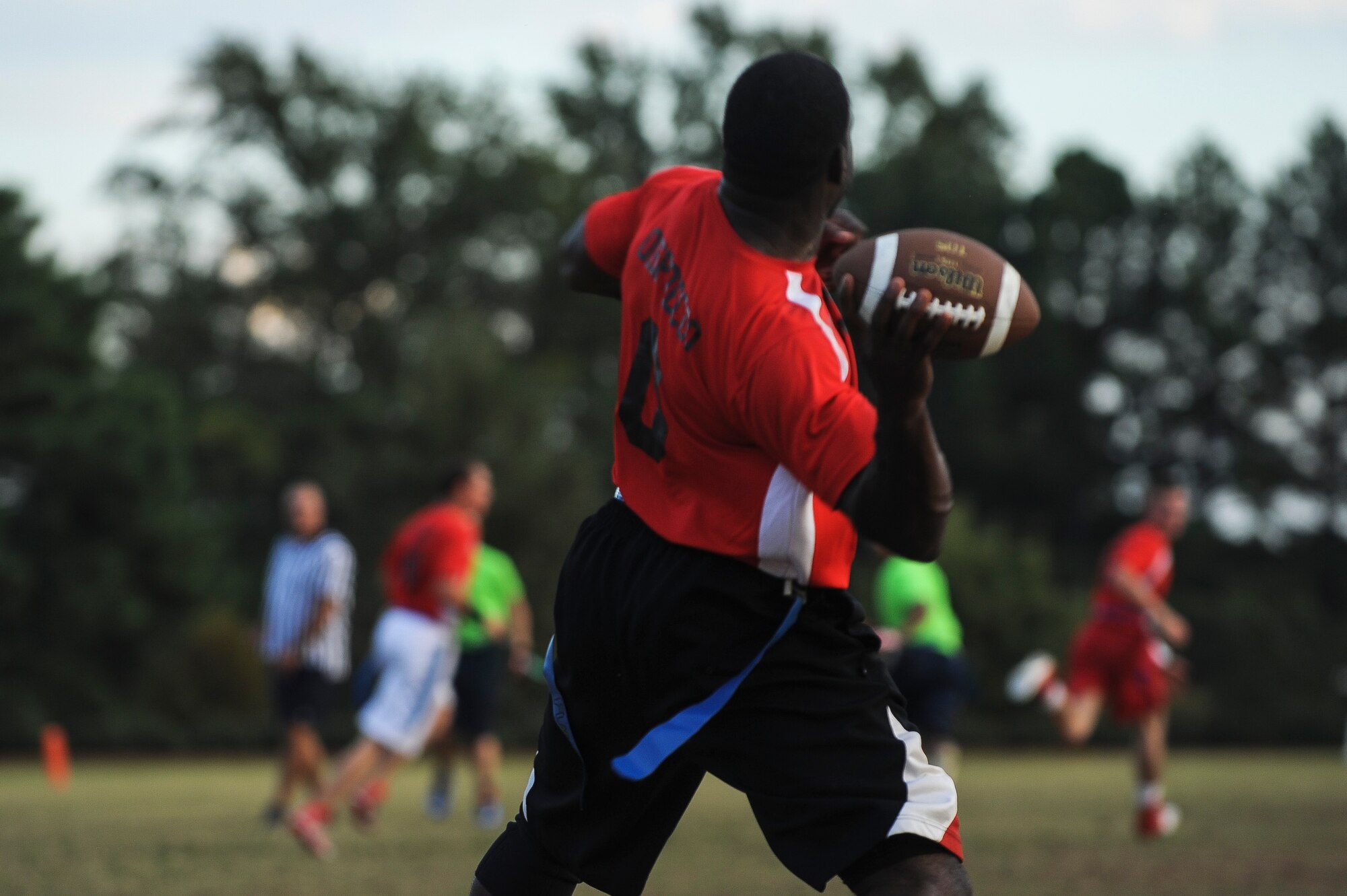 Senior Airman Ernest Opoku quarterback for the 19th Civil Engineer Squadron, rears back to toss a hail mary down the field to end the first half of an intramural flag football game Oct. 9, 2014, at Little Rock Air Force Base, Ark. The 19th CES struggled to maintain possession of the ball, turning it over a total of five times. (U.S. Air Force photo by Airman 1st Class Cliffton Dolezal)
