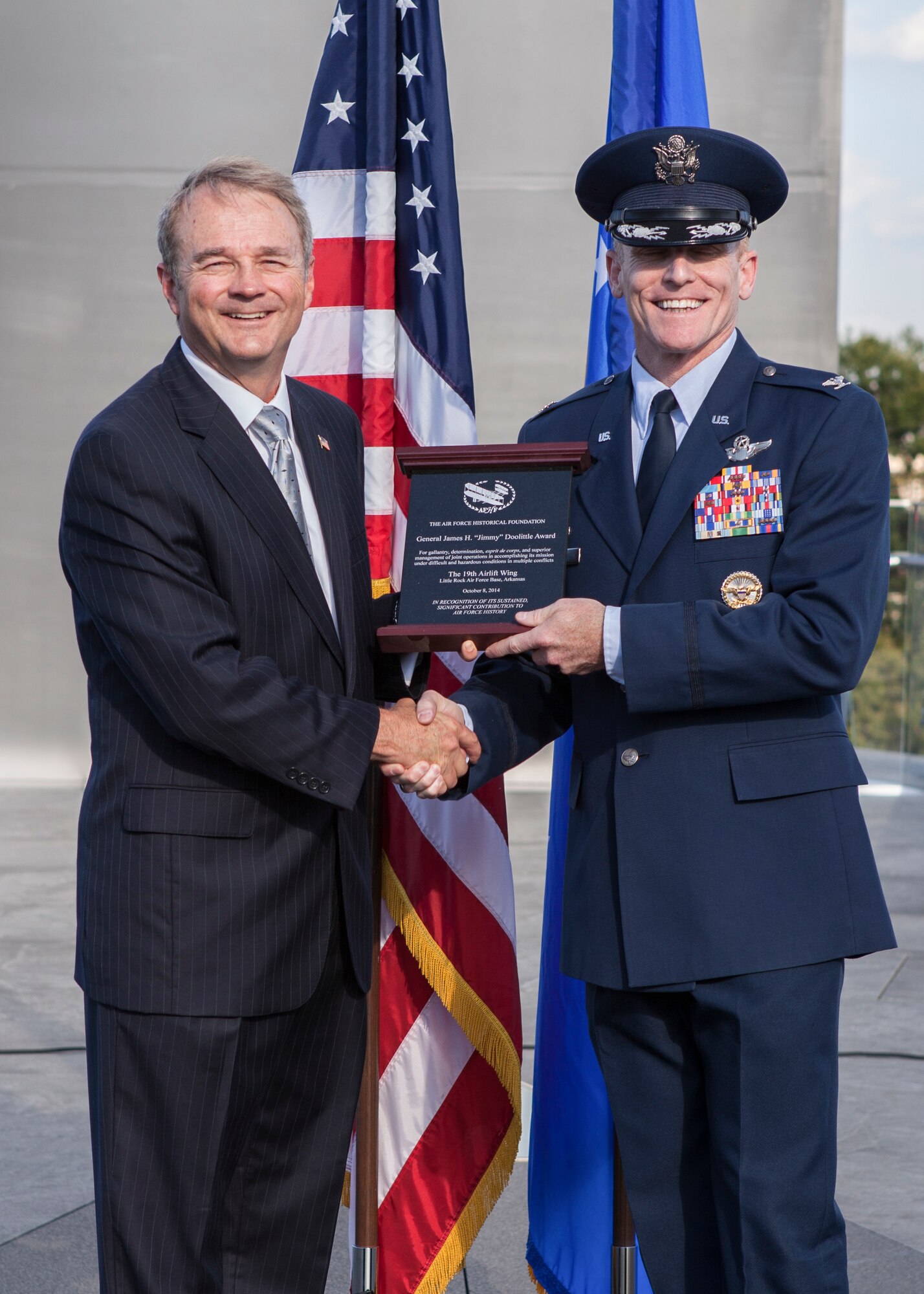 Col. Patrick Rhatigan, 19th Airlift Wing commander accepts the James H. “Jimmy” Doolittle Award from retired Maj. Gen. Dale Meyerrose, Air Force Historical Foundation president, at the Air Force Memorial Oct. 8, 2014, in Arlington, Virginia. The 19th AW was presented the James H. “Jimmy” Doolittle Award for significant contributions to airpower history. (U.S. Air Force photo by Master Sgt. Tara Islas)