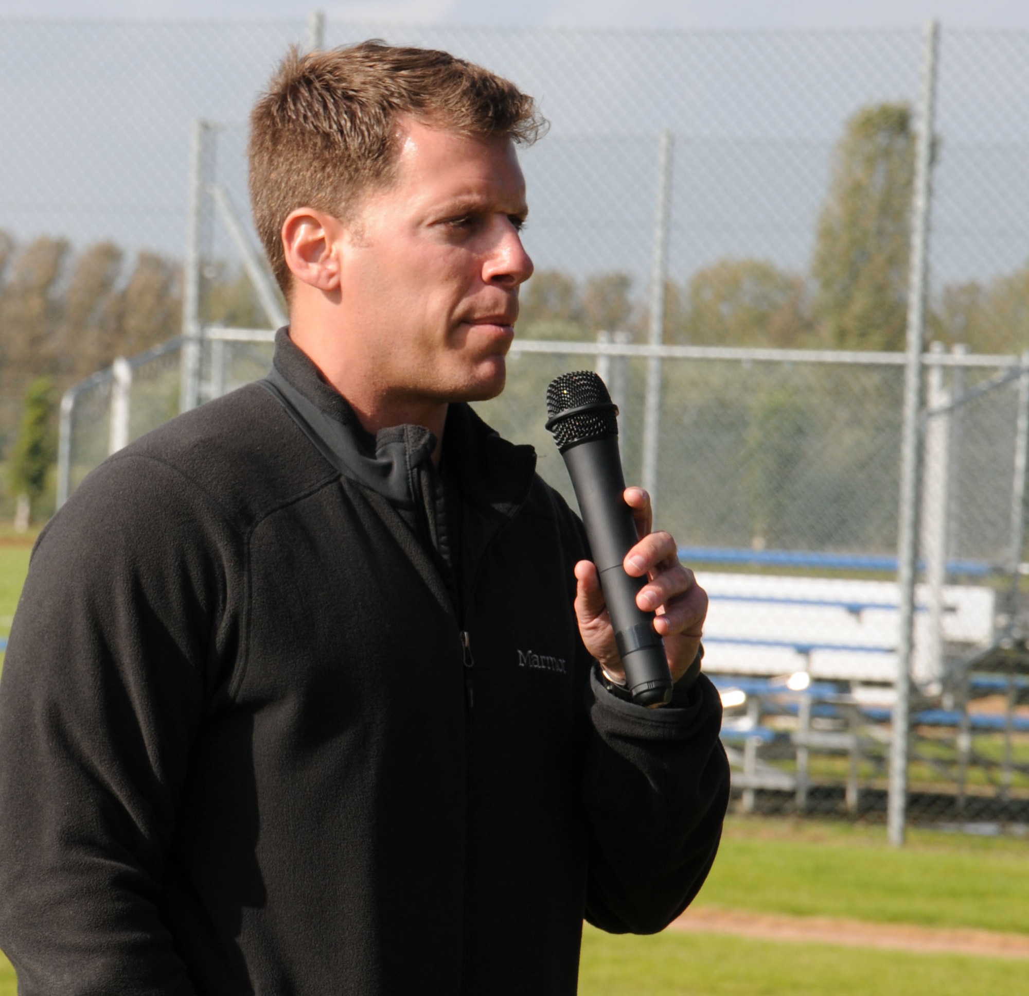 U.S. Air Force Capt. Joel Haarer, 100th Operations Support Squadron Airfield Operations flight commander from Phoenix, addresses participants during the Combined Federal Campaign Fitness Challenge Oct. 9, 2014, at Heritage Park on RAF Mildenhall, England. During the event, Haarer motivated the teams with encouraging words and announced the final time for each team as they completed the last event. (U.S. Air Force photo/Gina Randall/Released)