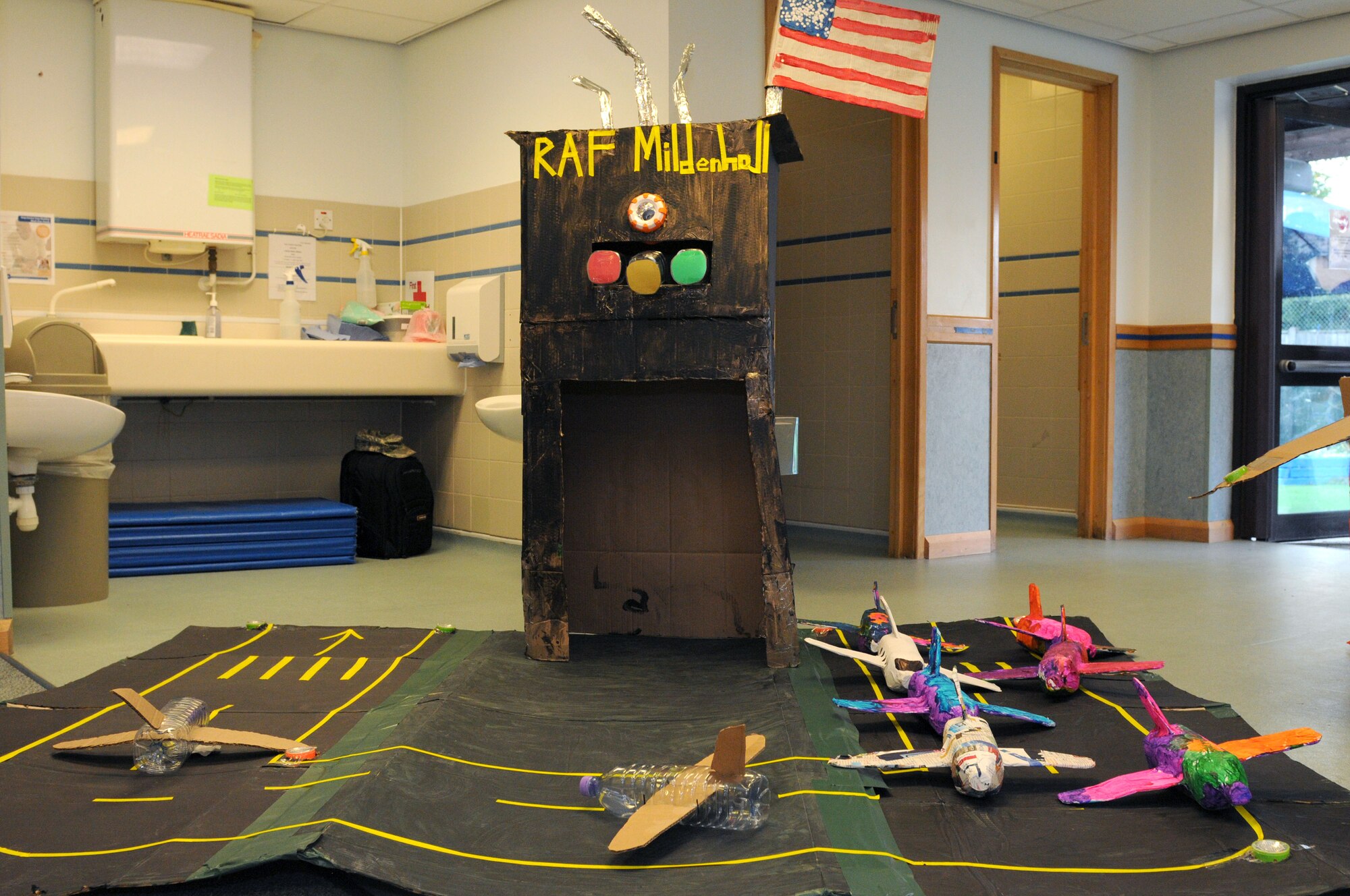 A cardboard representation of RAF Mildenhall is part of a cardboard English village Oct. 10, 2014, at the Child Development Center on RAF Mildenhall, England. The village was created by Airmen and their families for this year’s Global Cardboard Challenge presented by the Imagination Foundation which encourages children and their communities to build items to mind out of cardboard, recycled materials and their imagination. (U.S. Air Force photo/Senior Airman Kate Maurer/Released)